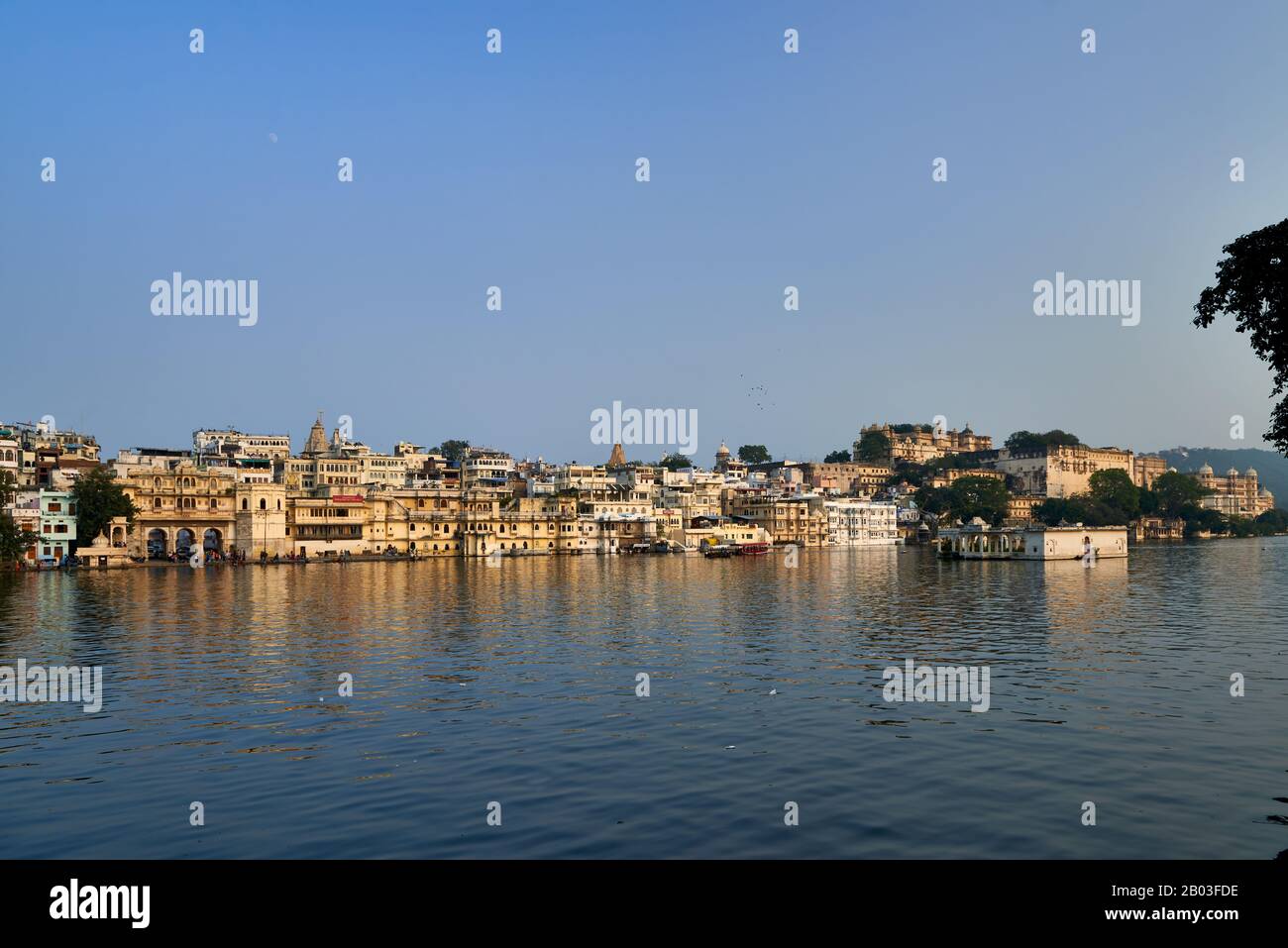 Panorama filmado sobre el lago Pichola con Gangaur Ghat, el palacio de la ciudad y el palacio Taj Fateh Prakash en Udaipur, Rajasthan, India Foto de stock