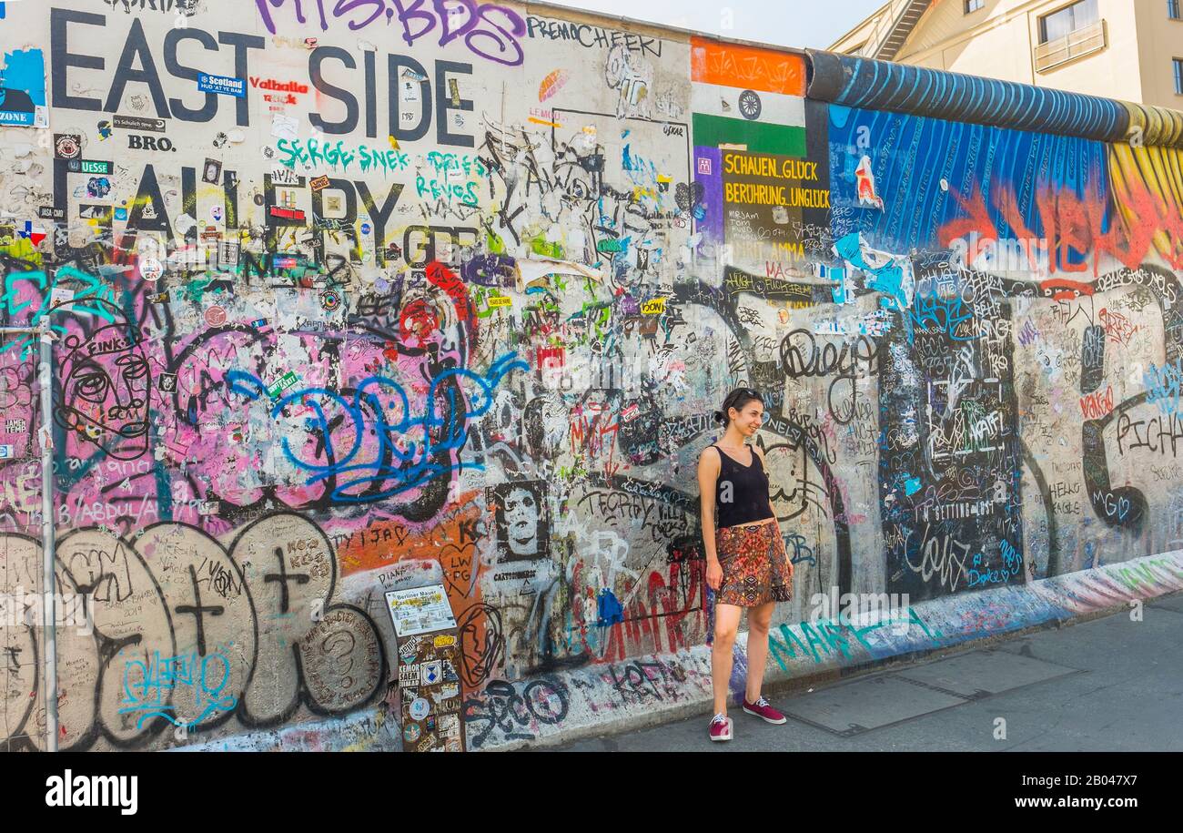 mujer joven posando frente al mural en la galería del lado este Foto de stock