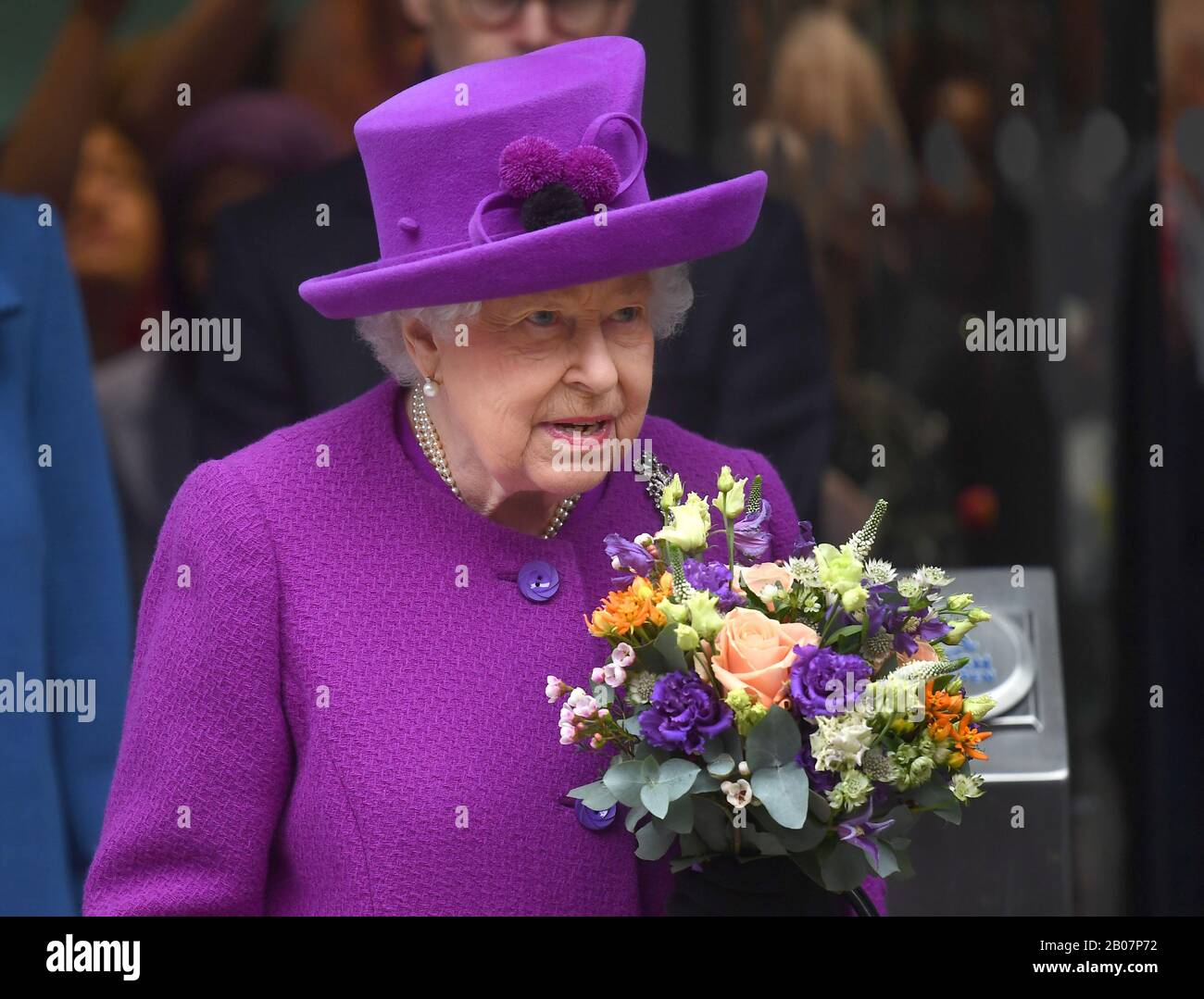 La Reina Isabel II lleva un ramo cuando se va después de abrir oficialmente las nuevas instalaciones del Royal National ENT y los Eastman Dental Hospitals en Londres. Foto de stock