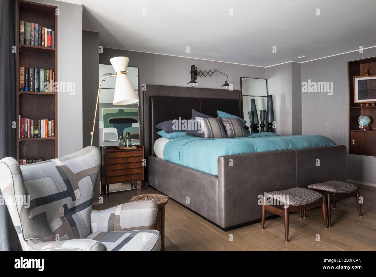 Diablo lámpara de pie modernista y silla tapizada en el dormitorio del apartamento del oeste de Londres Foto de stock