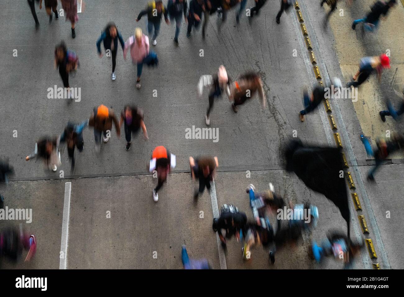 Los estudiantes corren por la carretera durante una marcha de protesta contra las políticas del gobierno en Bogotá, Colombia. Foto de stock