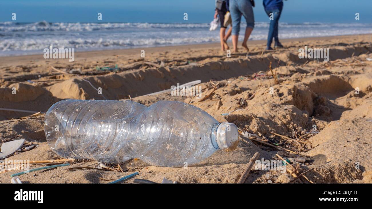 Botella de plástico en la playa, contaminación Foto de stock