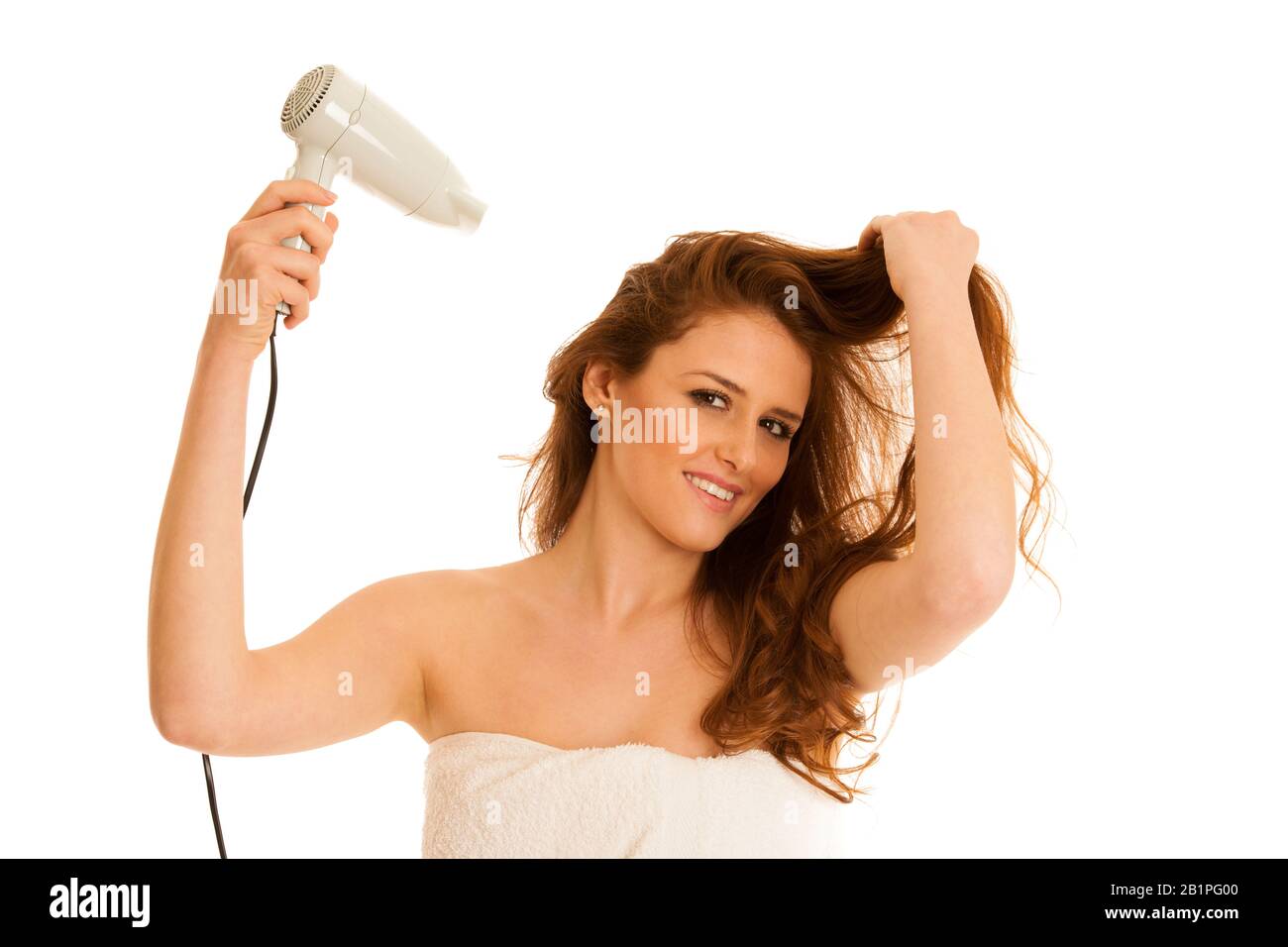 hermosa mujer joven seca el pelo con un secador de pelo Foto de stock