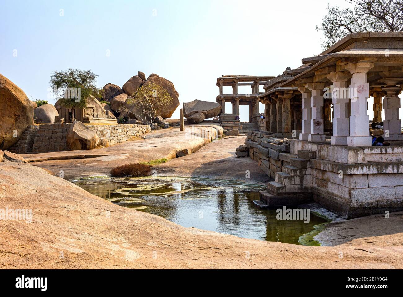 Hermosa vista de las ruinas con un pequeño estanque. El Grupo de Monumentos en Hampi fue el centro del Imperio hindú Vijayanagara en el estado de Karnataka en I Foto de stock