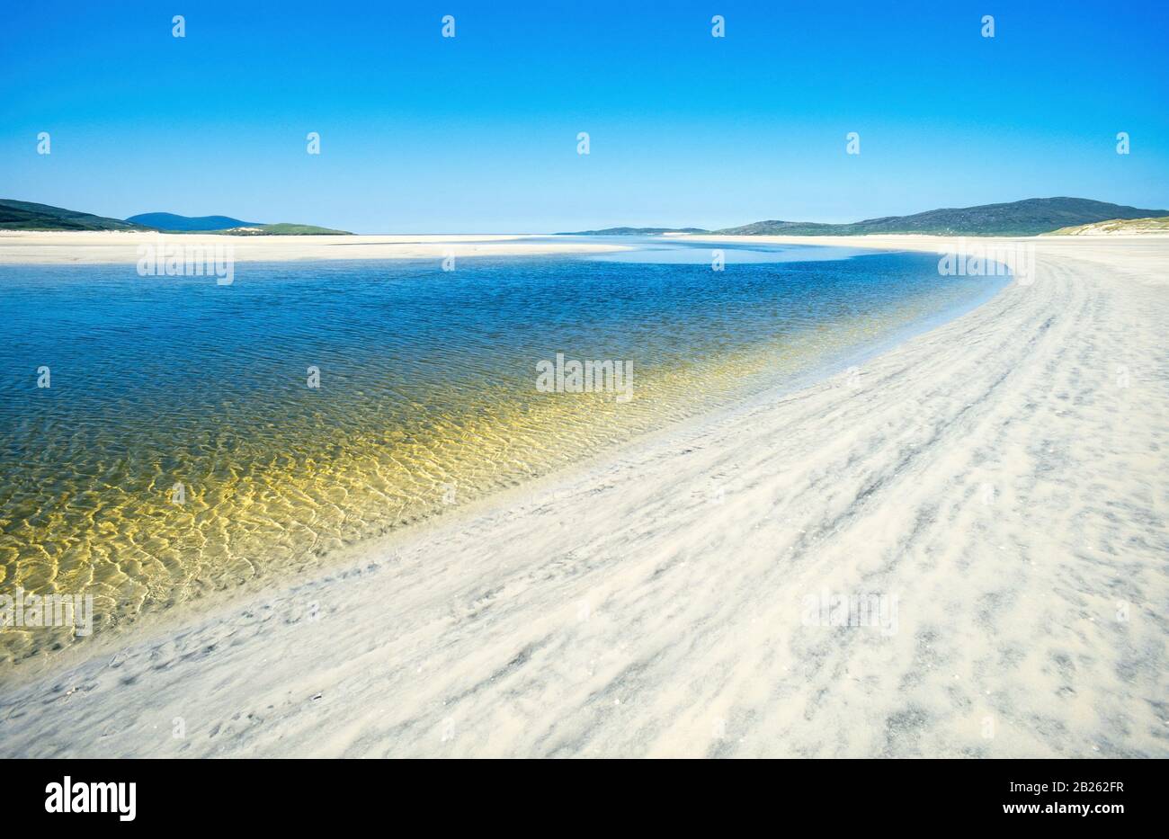 Arenas y agua a la luz del sol en la playa de Luskentire (Losgaintir) en un hermoso día de verano en junio con cielo azul, Isla de Harris, Escocia, Reino Unido Foto de stock