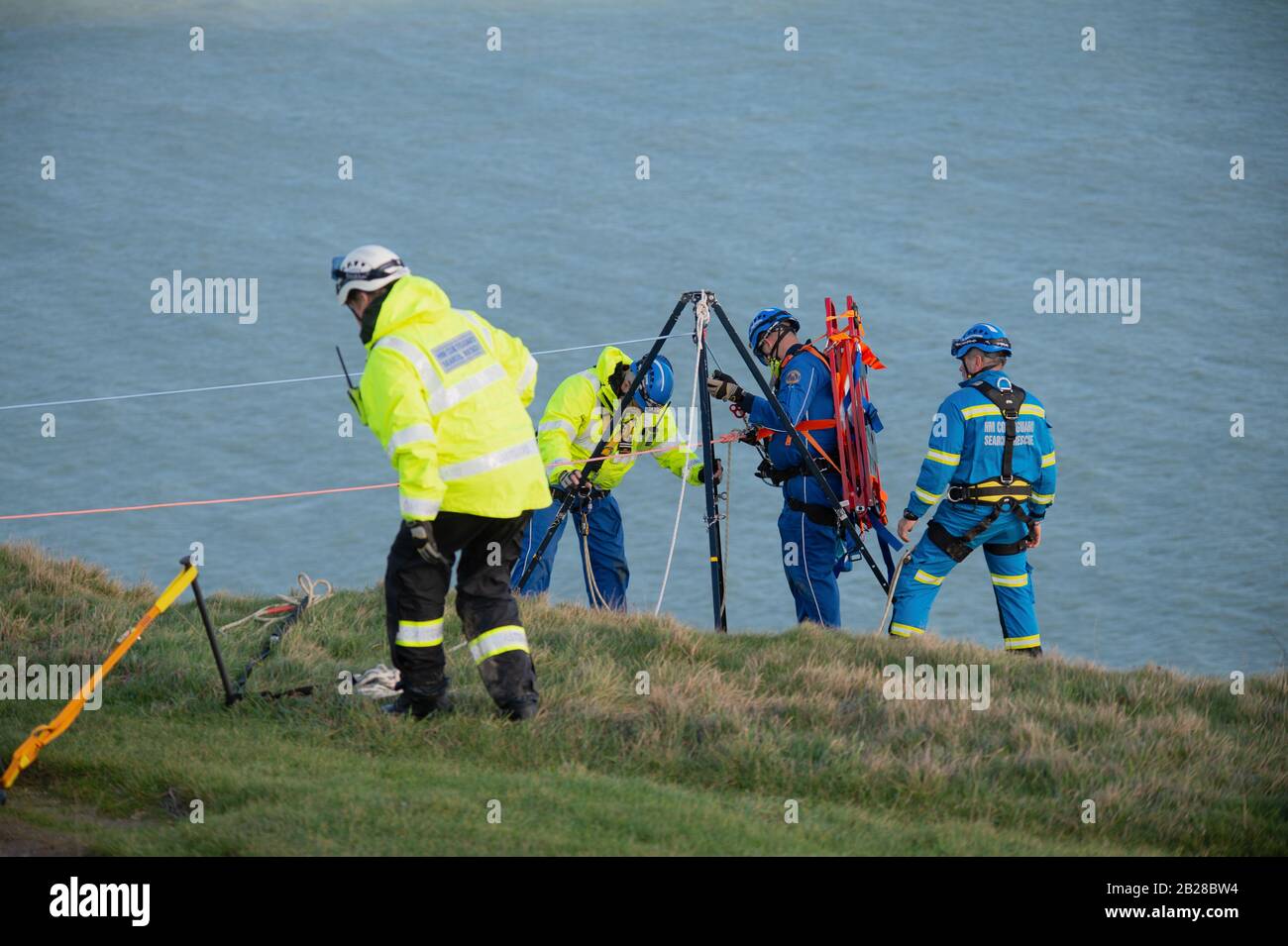 HM Coastguard prepárese para bajar por los acantilados blancos cerca de Dover Kent para recuperar un cuerpo muerto de la playa de abajo. Foto de stock