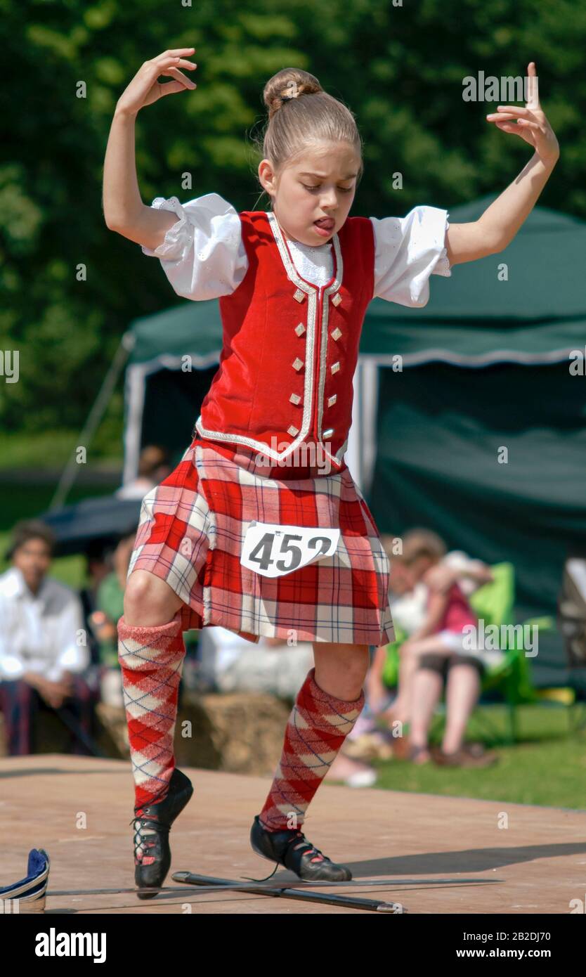 Joven bailarín escocés Highland realizando una danza de espada durante una competición en Colchester, Essex, Inglaterra Foto de stock