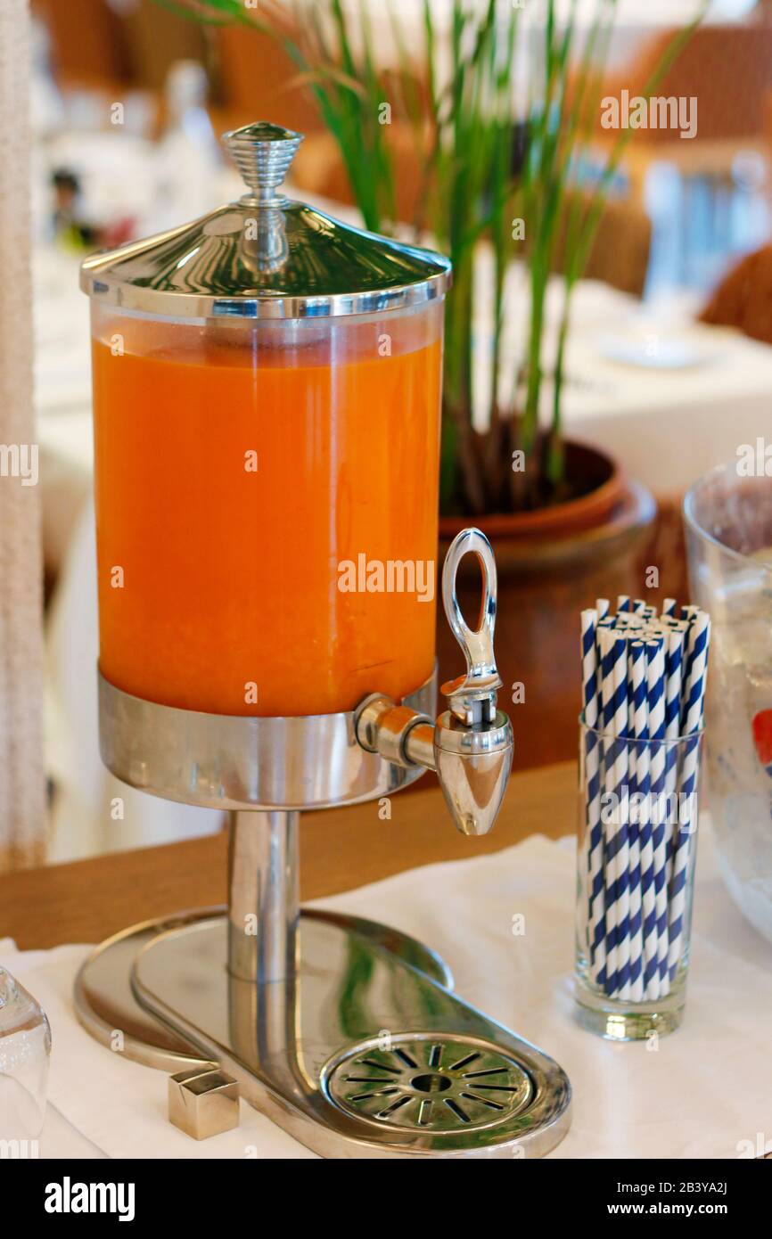 Dispensador de zumo de fruta con paja de papel en el mostrador de  autoservicio del desayuno en el restaurante del hotel Fotografía de stock -  Alamy