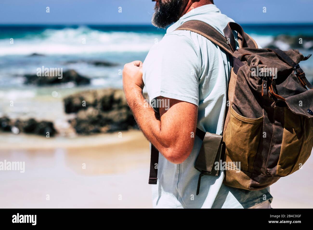 Primer plano de la gente adulta hombre viaje con mochila de cuero estilo - alternativo vacaciones al aire libre concepto y mar de en el fondo - disfrutar de