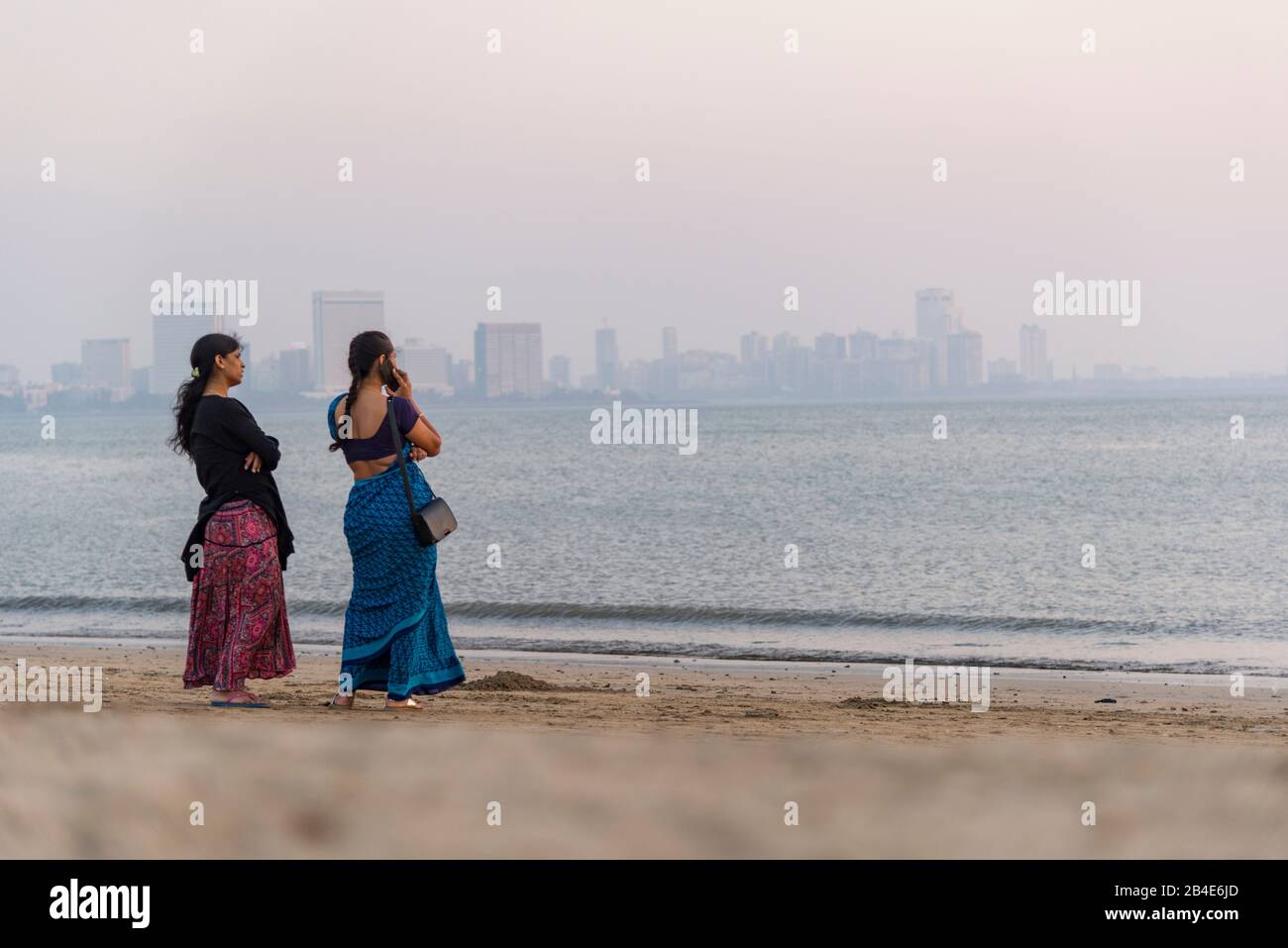 India, Maharashtra, Mumbai, Gente En Chowpatty Beach, Puesta De Sol, Skyline, Foto de stock