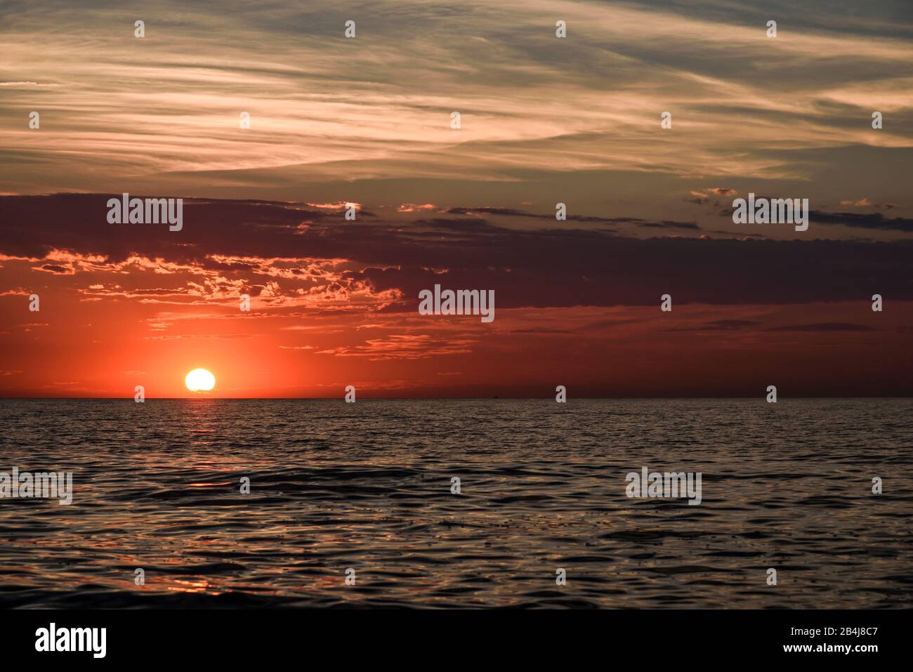 Vista sobre el mar Báltico en la península Fischland Darß con poco antes en el mar puesta de sol con el cielo dramático en el verano Foto de stock