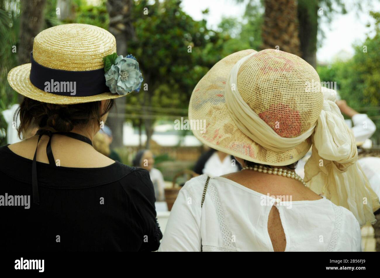 Dos mujeres modernistas con grandes sombreros vintage con flores pasando  tiempo fuera Fotografía de stock - Alamy
