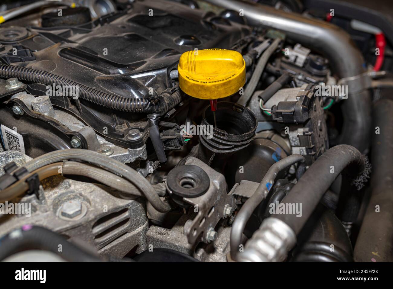 Compartimiento del motor en el vehículo usado visible abra el relleno de  aceite en amarillo y partes del motor Fotografía de stock - Alamy