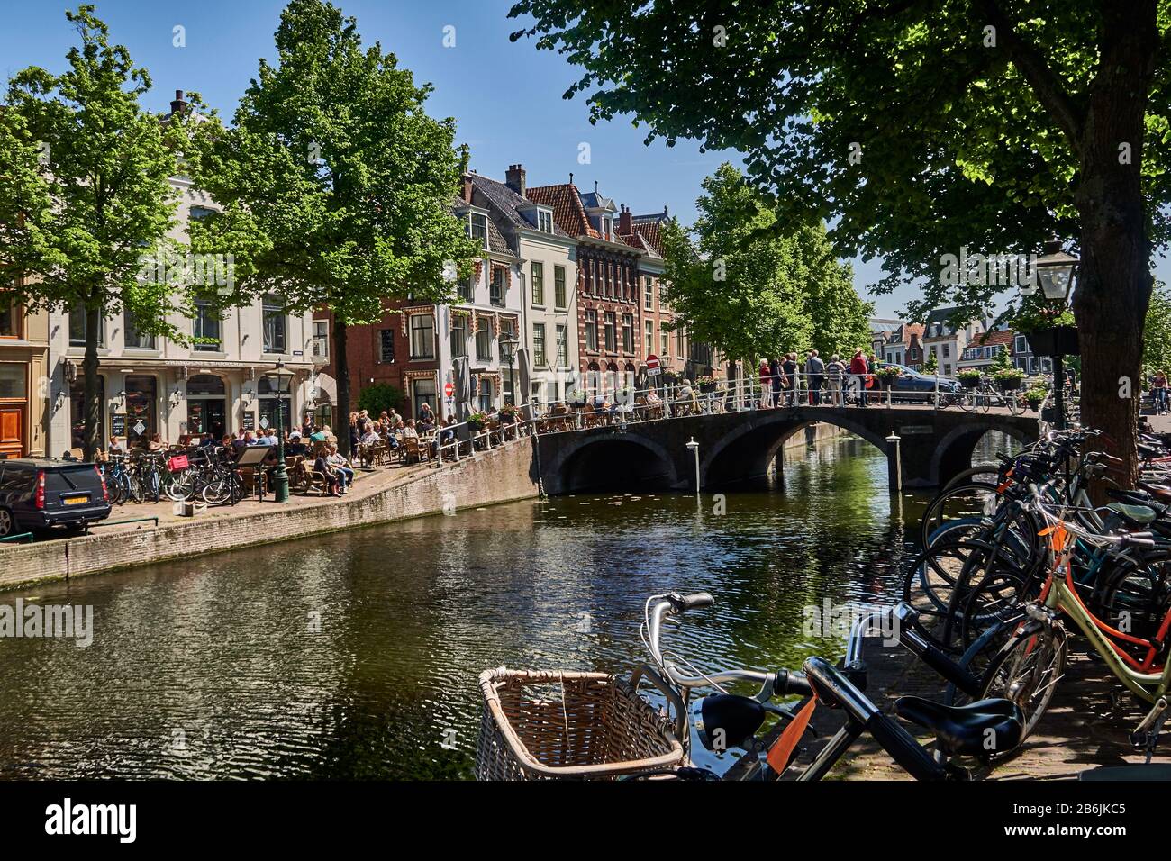 ciudad de Leiden, provincof South Holland, países Bajos, Europa, la gente se relaja a lo largo del canal holandés Rapenburg en el centro histórico de Leiden., la ciudad de Leiden es conocida por su arquitectura secular, sus canales, su universitof 1590, la nativitof Rembrand, La ciudad donde floreó el primer tulipán bulof en Europa en el siglo 16 Foto de stock