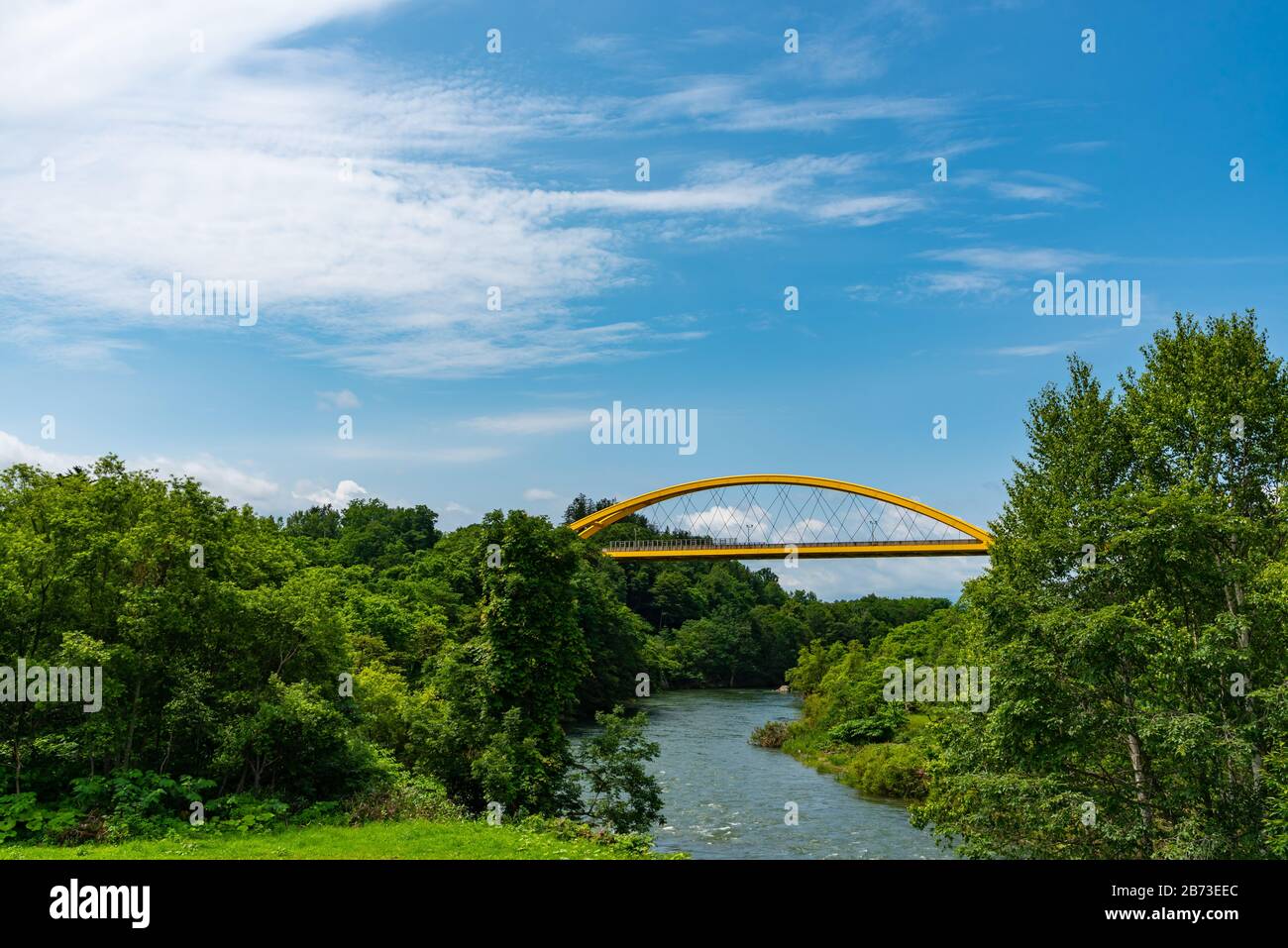 Puente de Niseko en la primavera, un puente amarillo que atraviesa la línea principal de Hakodate y el río Shiribetsu Foto de stock