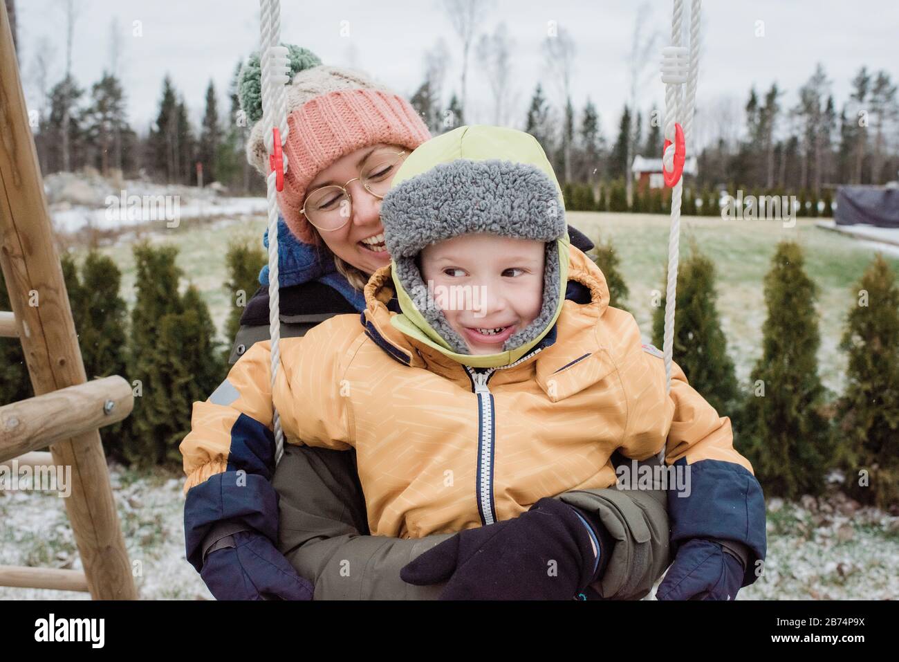 madre e hijo riendo divertirse jugando afuera en la nieve Foto de stock