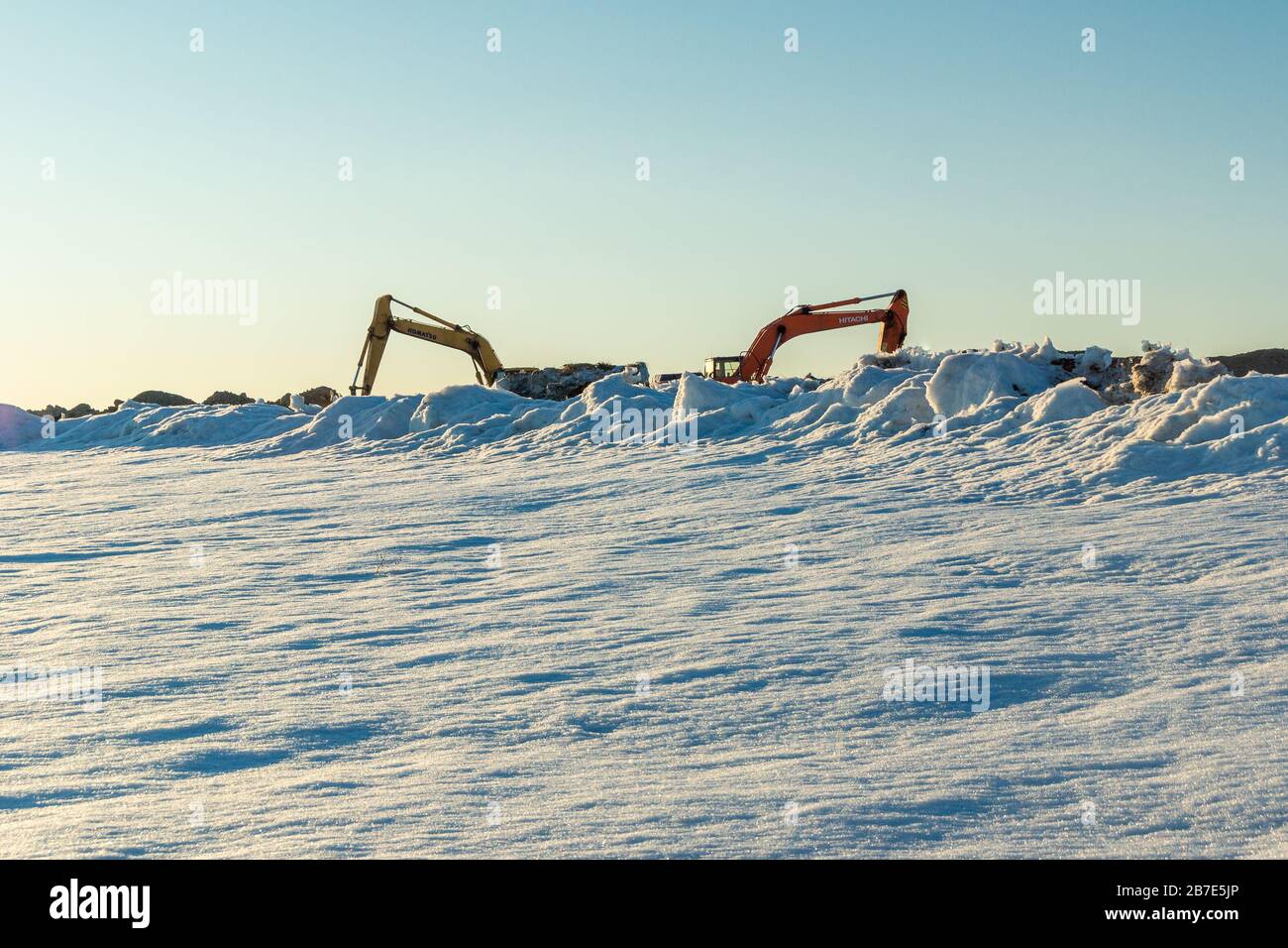 Kemerovo, Rusia - Marzo de 2019, limpieza de nieve y excavación por excavadoras Hitachi y Komatsu Foto de stock