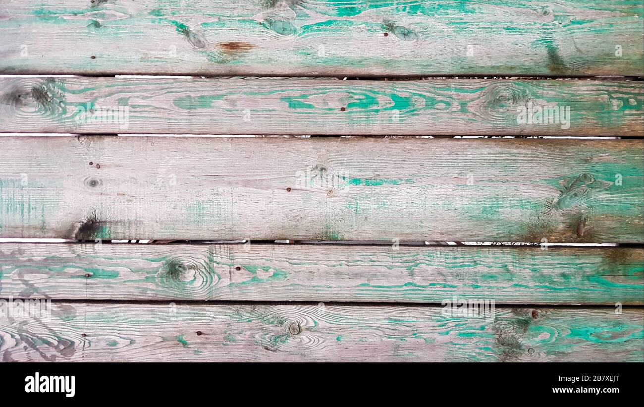 Imagen de fondo hecha de viejas tablas de madera verde. Textura pared