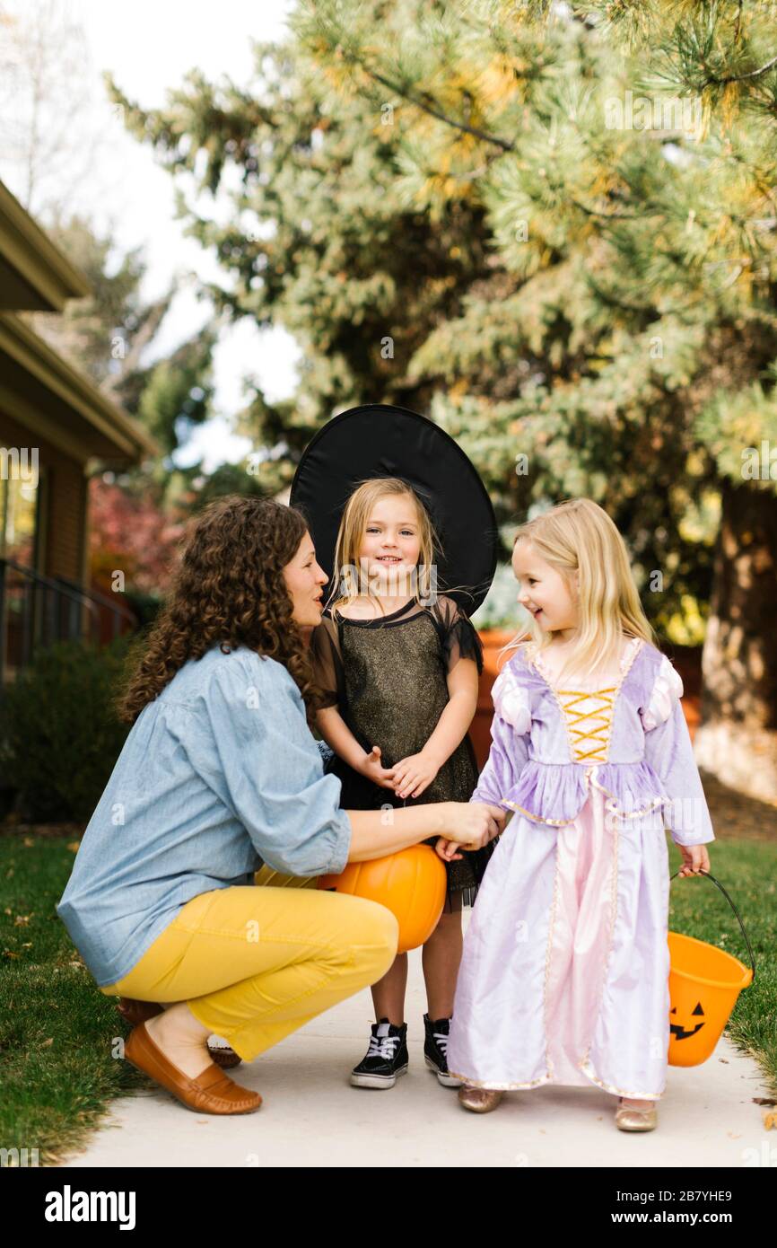 Chicas en disfraces de Halloween con su madre Foto de stock