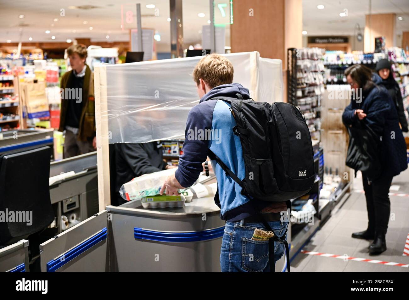 ALEMANIA, Hamburgo, Corona virus, COVID-19 , supermercado con protección para el cajero para evitar infecciones Foto de stock