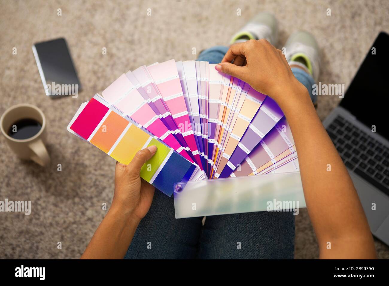 Chica que elige la pintura brillante con muestra de color Fotografía de  stock - Alamy