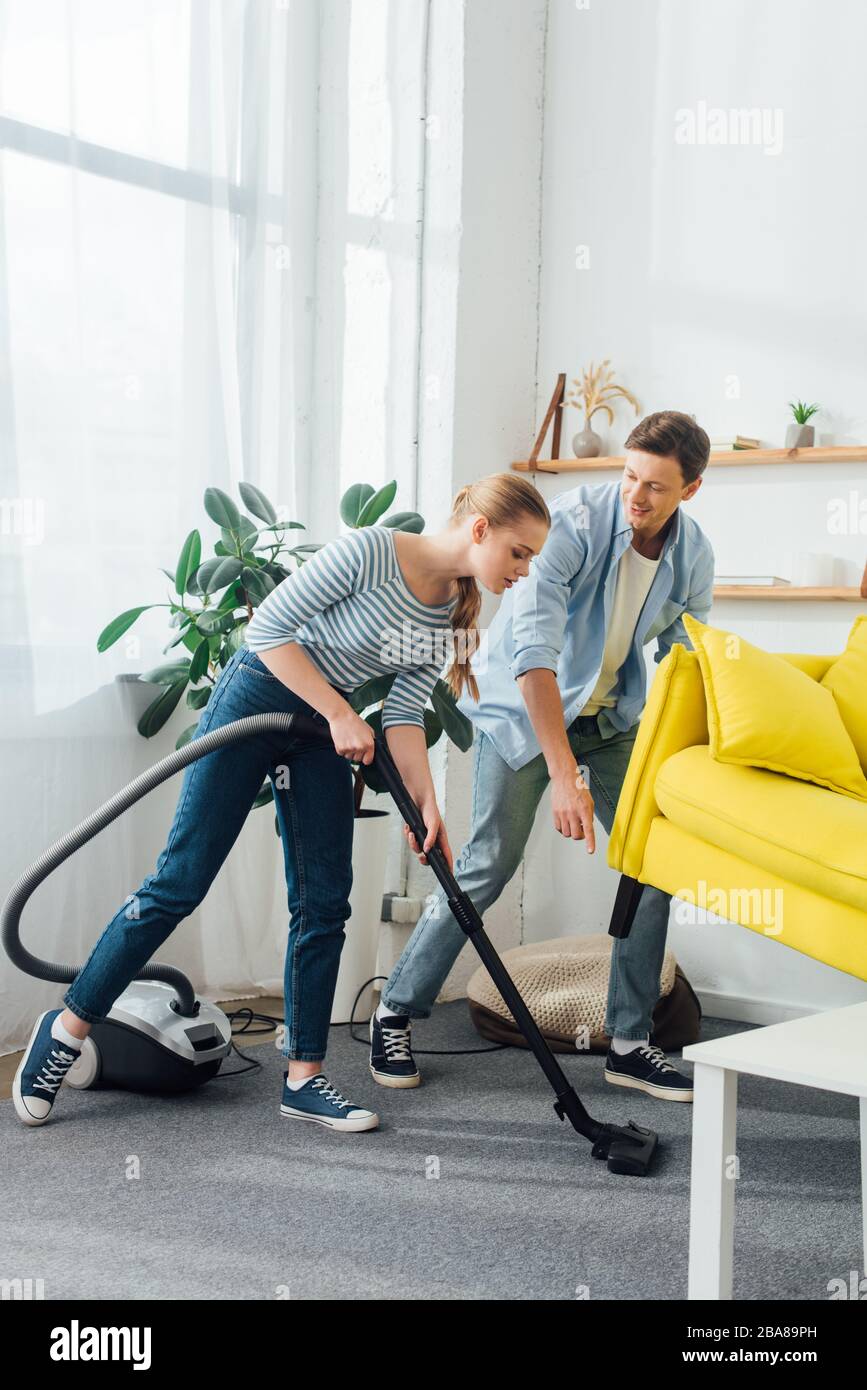 Woman vacuuming sofa fotografías e imágenes de alta resolución