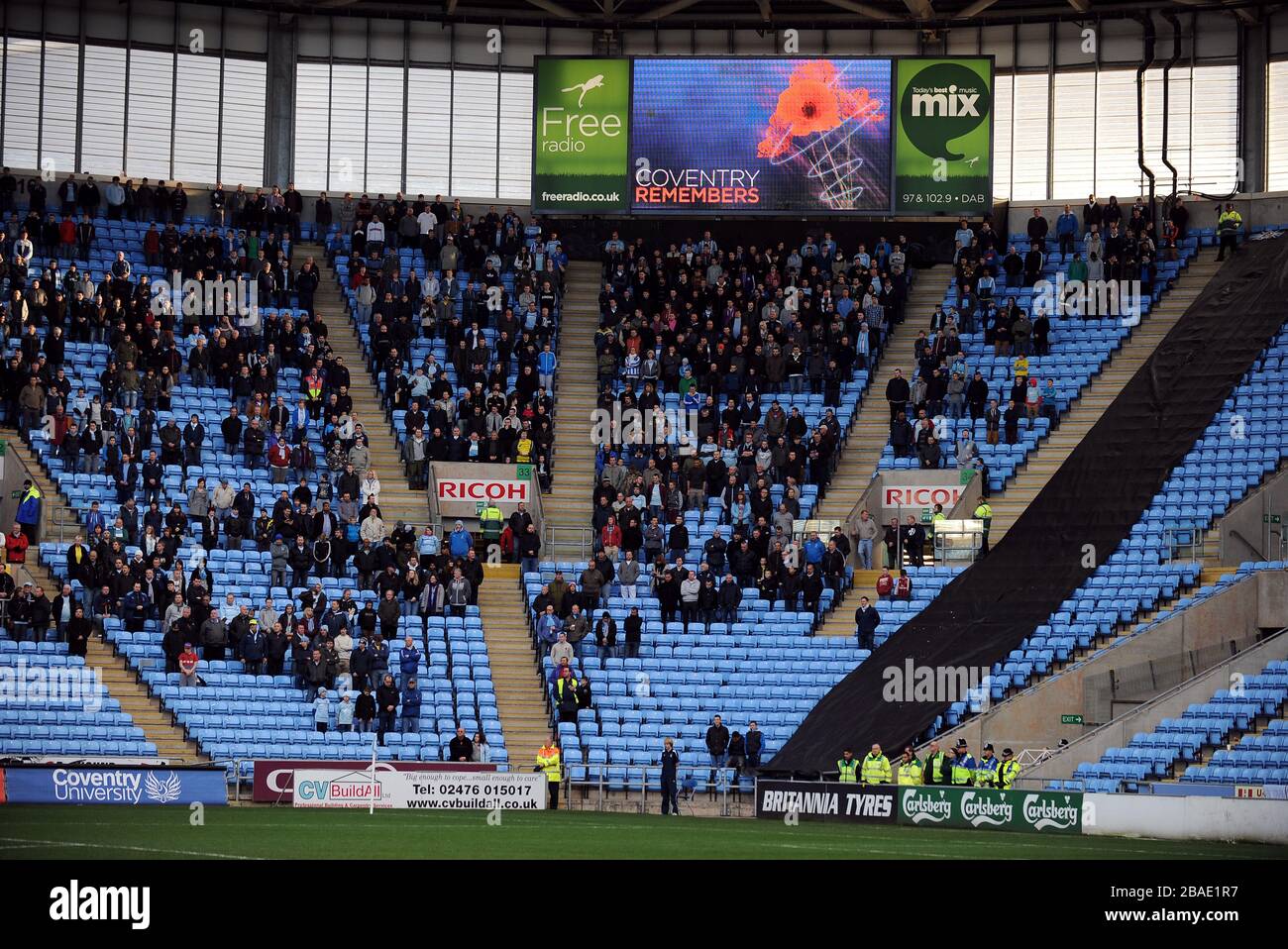Los fans de Coventry City en los stands observan el silencio de los minutos Foto de stock