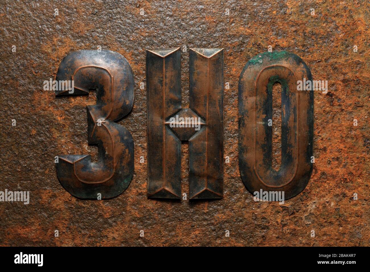 Fondos y texturas: Grupo de letras cirílicas de cobre en relieve envejecidas sobre una superficie de metal oxidado muy corroída Foto de stock
