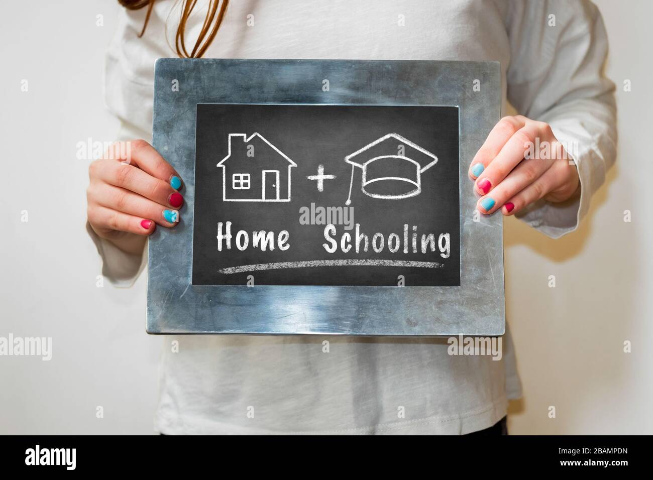 Dibujo de pizarra de un hogar y sombrero de graduación. Concepto de homeschooling. Foto de stock