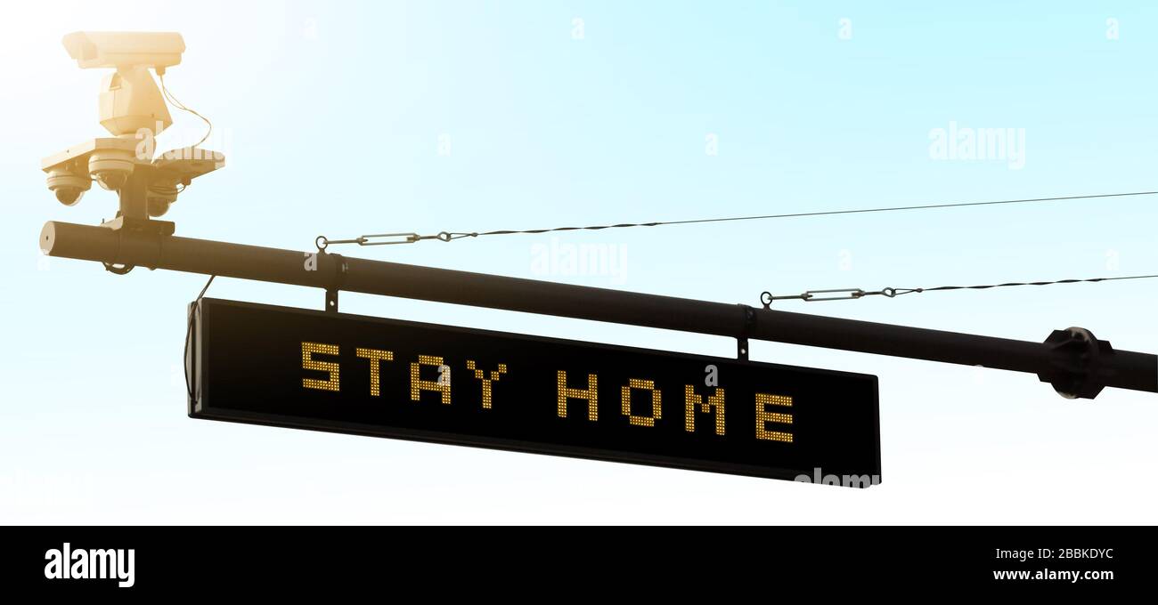 Autopista con tablero de información. Título 'Stay at home'. Prohibición de movimiento en cuarentena Foto de stock