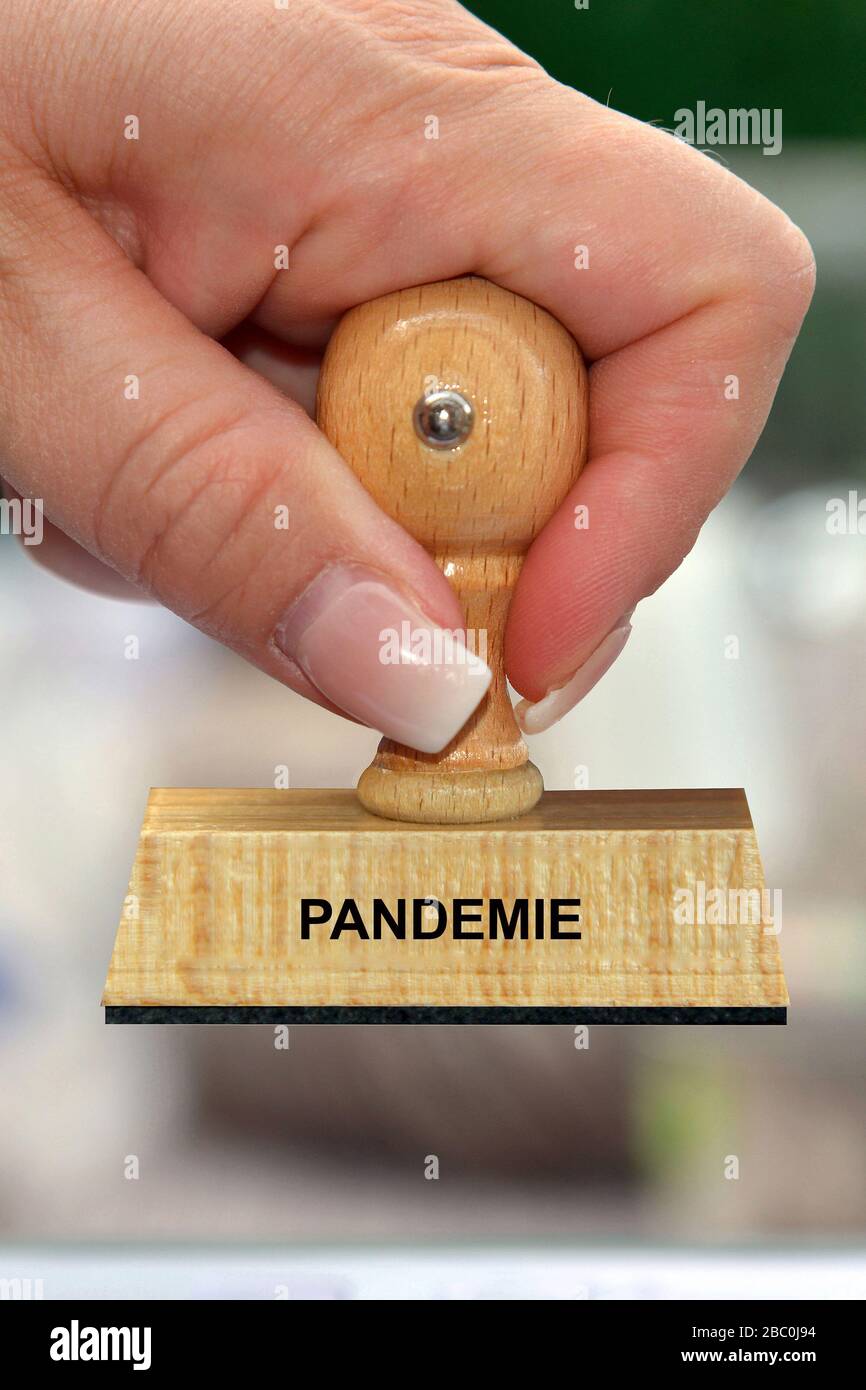 Hand mit Stempel, Frauenhand, Aufschrift: Pandemie Foto de stock