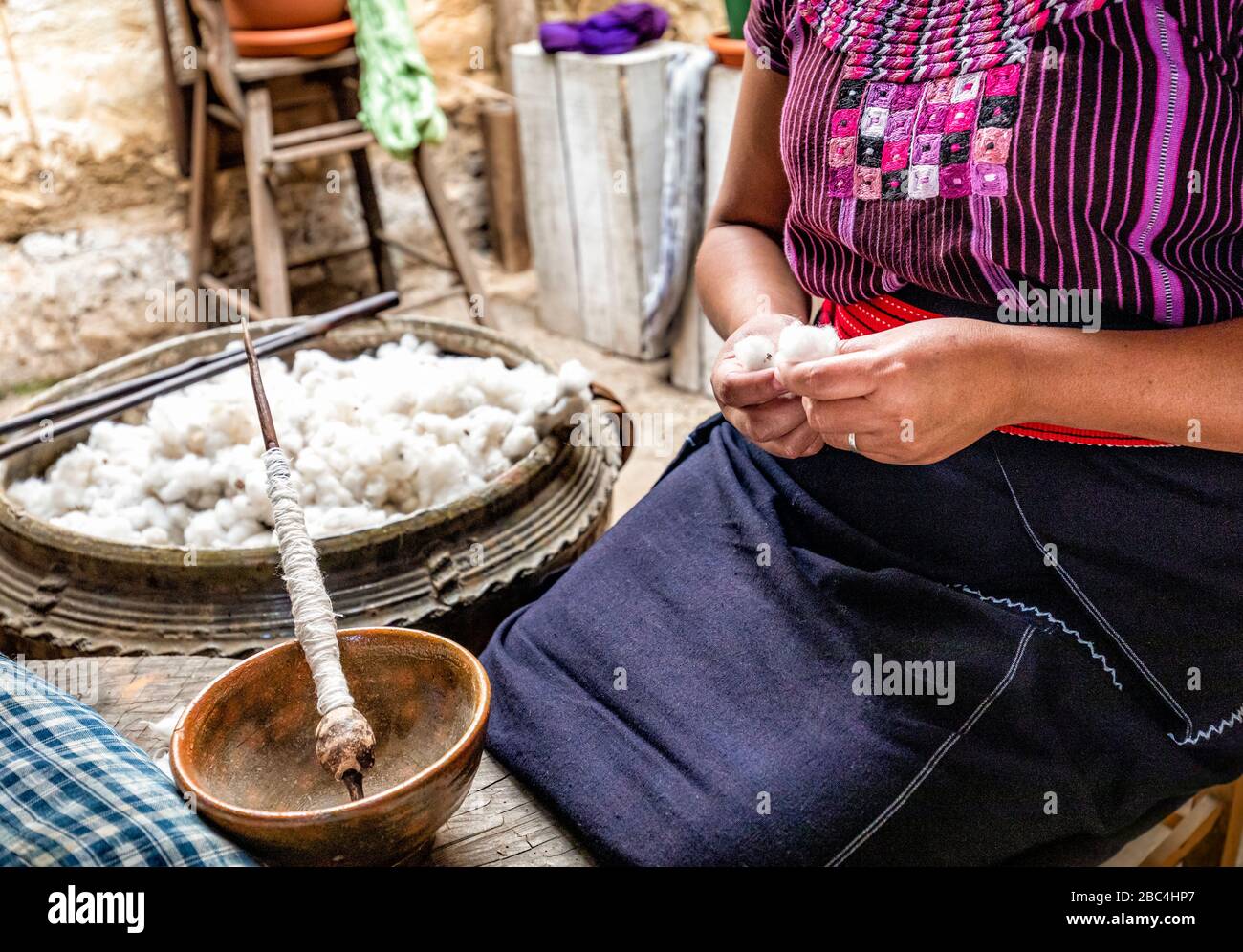 El algodón y el huso utilizado en este proceso artesanal en una cooperativa de tejeduría en San Juan a orillas del Lago Atitlán, Guatemala. Foto de stock