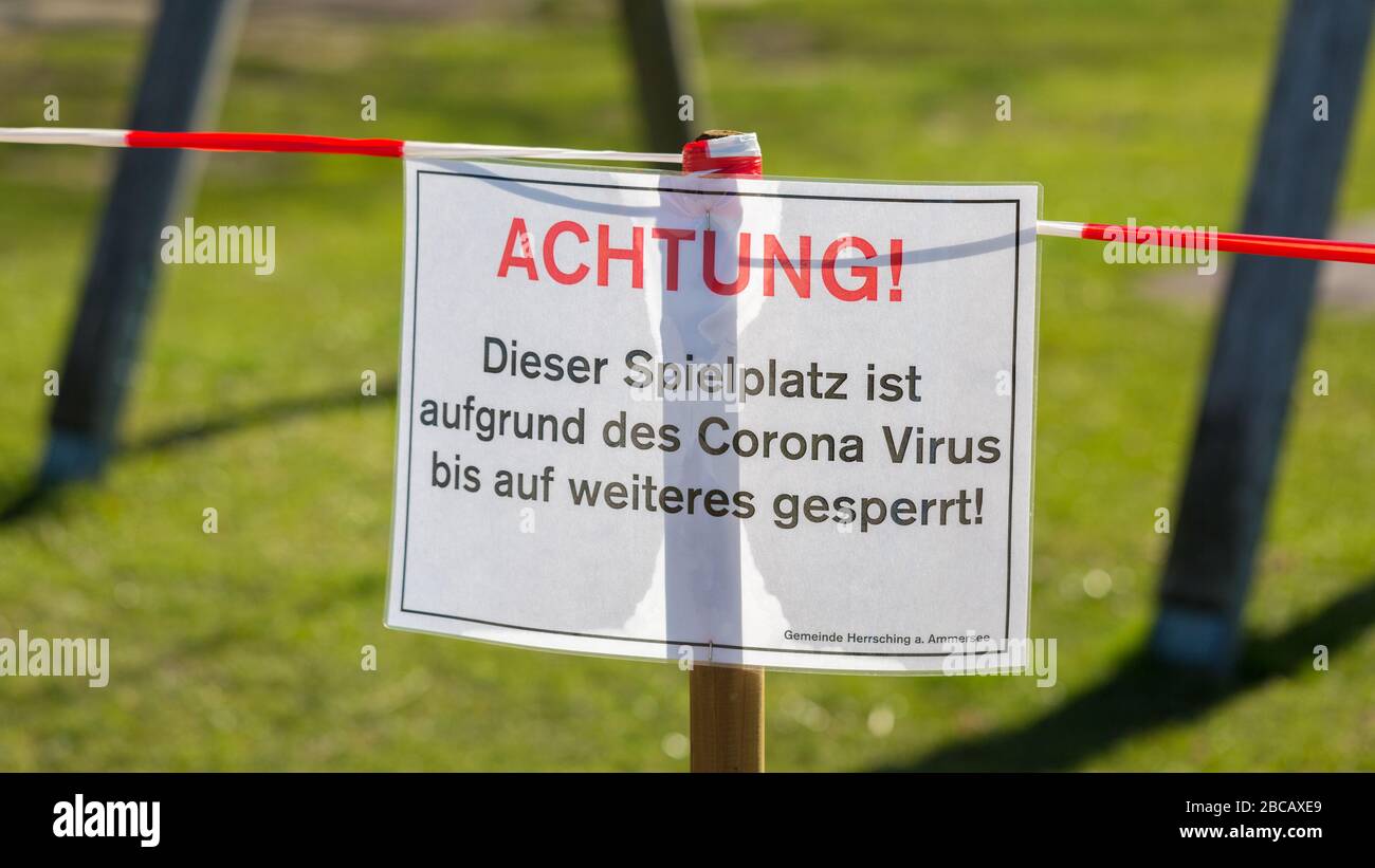 Cerca de la señal en el patio cerrado (Spielplatz). Con una palabra típica alemana: Achtung! (¡atención!). Restricciones debidas a Covid-19 / Coronavirus. Foto de stock