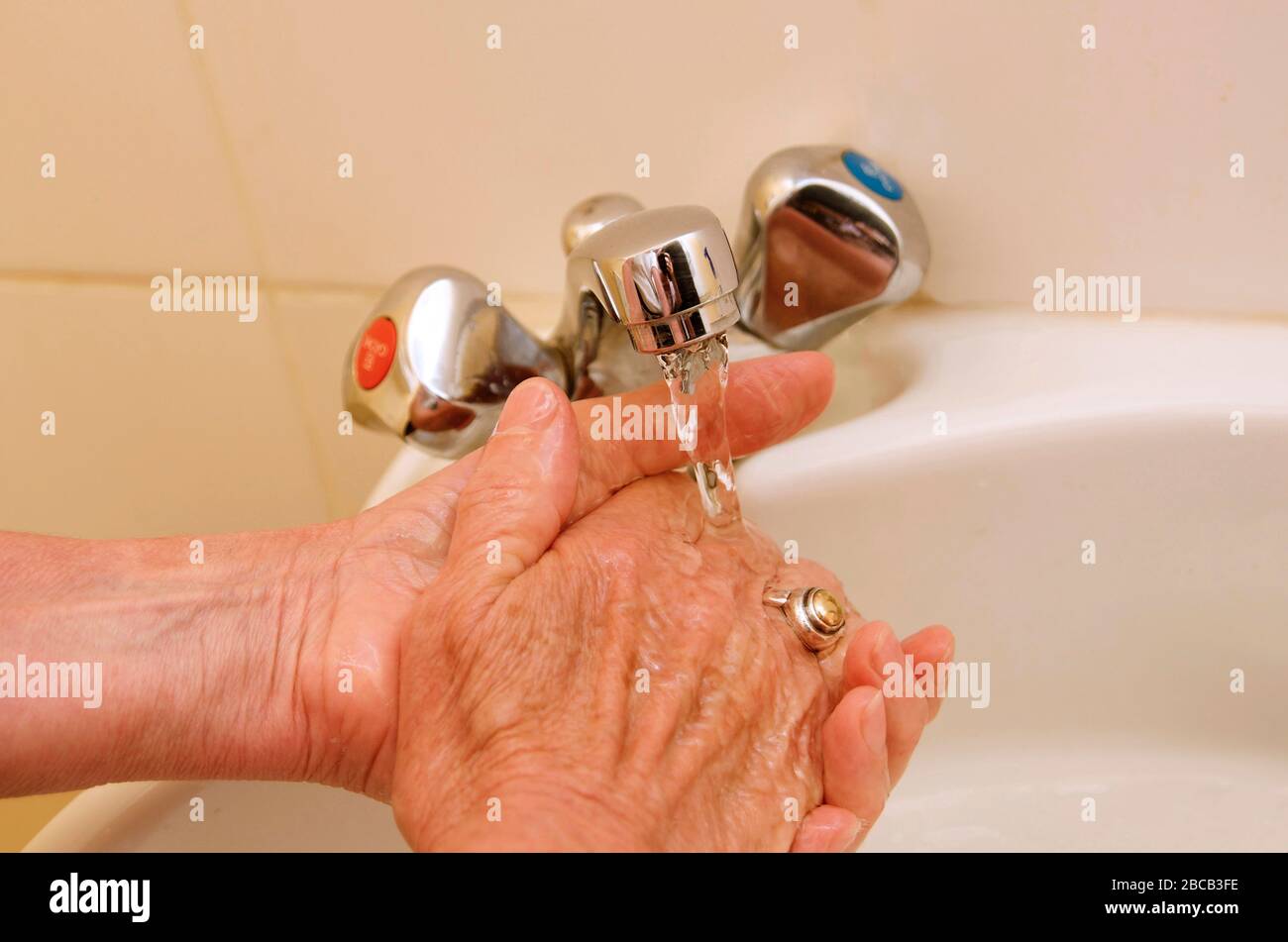Lavarse las manos con una llave de agua Foto de stock