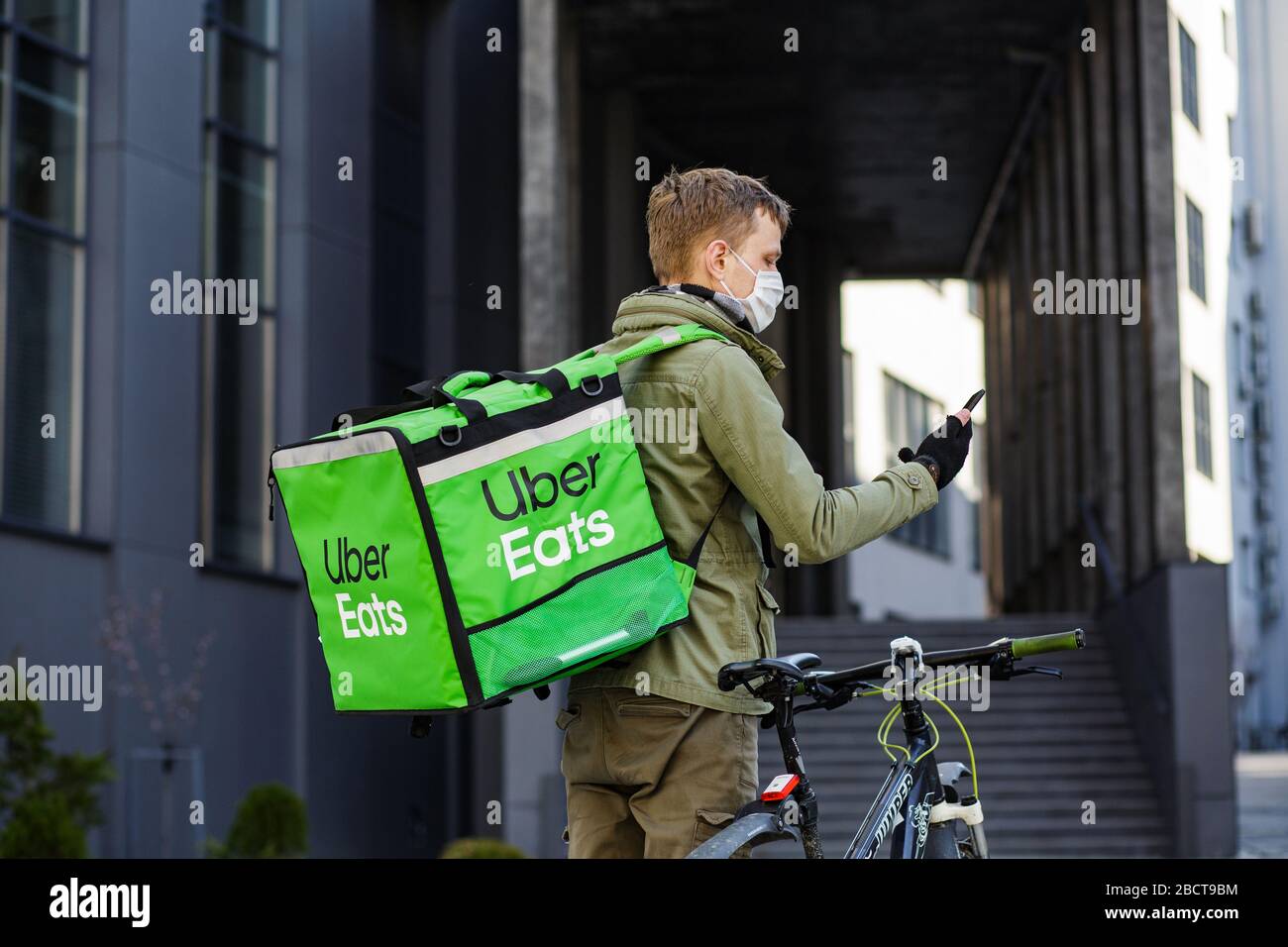 Proveedor de alimentos con mochila Uber Eats montando una bicicleta en el  plato Fotografía de stock - Alamy