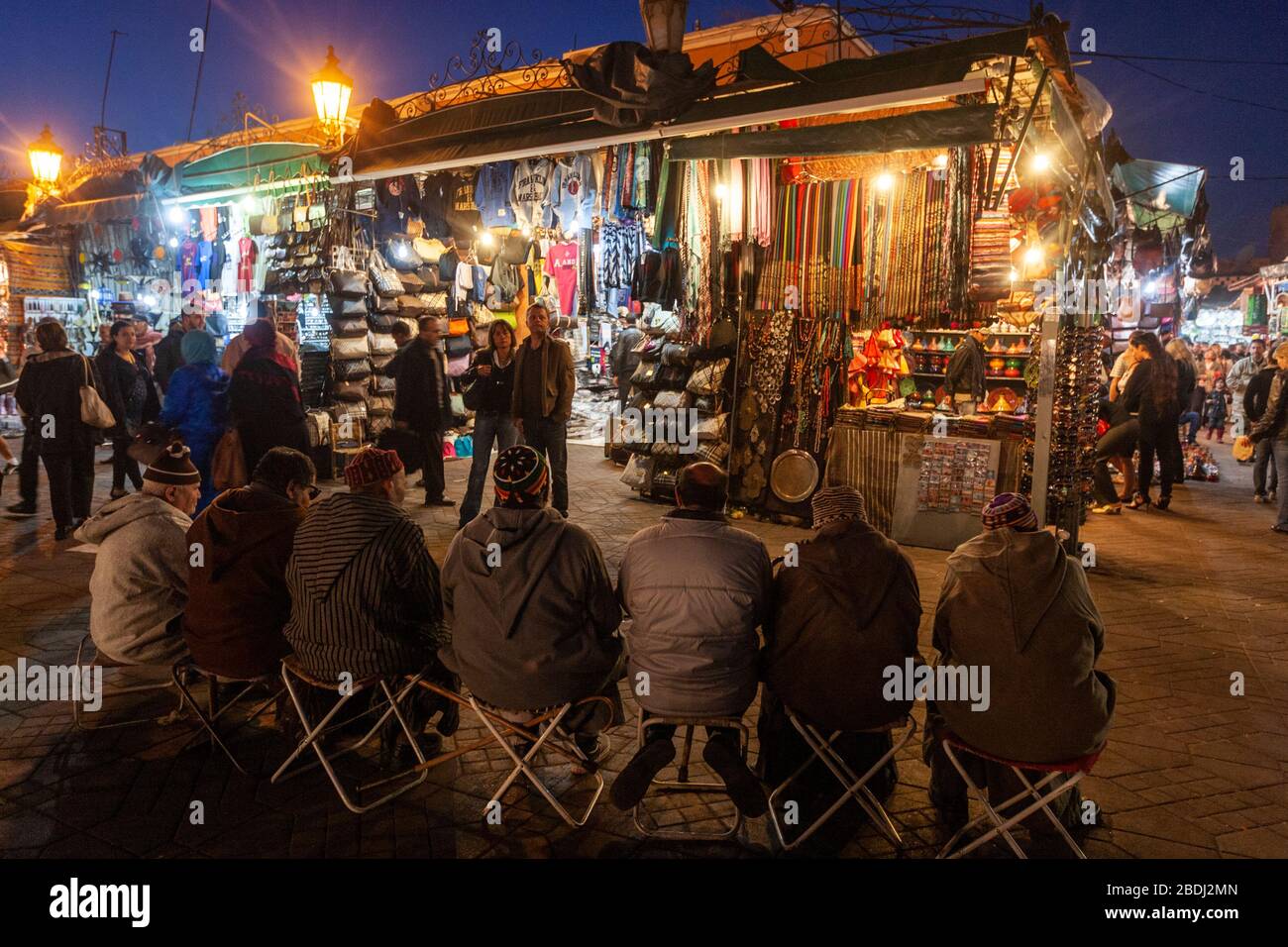 Hombres sentados en una fila en Jemaa el-Fnaa, Marrakech Fotografía de  stock - Alamy