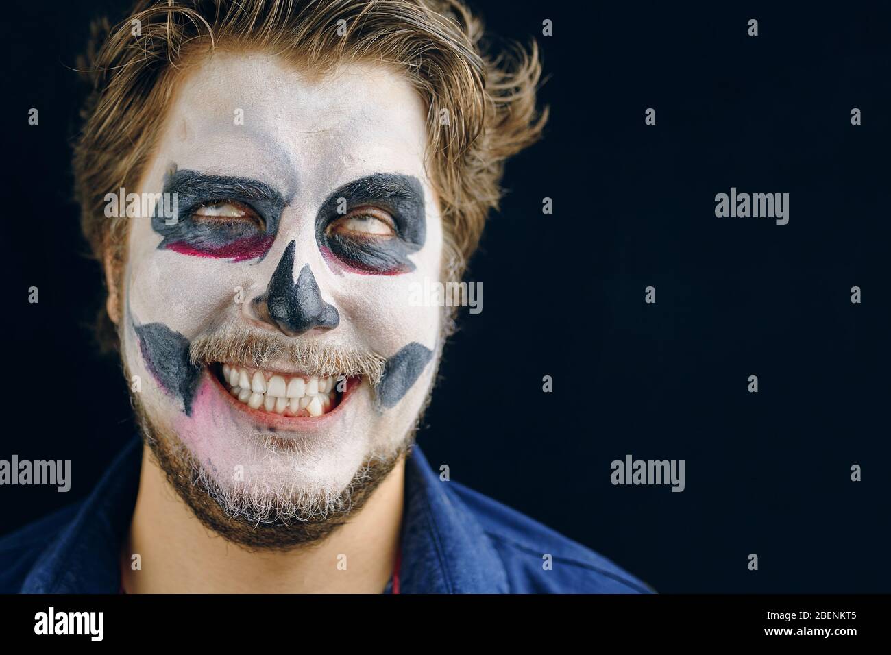 Rodó los ojos, sonríe con escabeche, cabello destartalado, mirada loca. Maquillaje  hombre del día de la muerte en Halloween. Espacio de copia Fotografía de  stock - Alamy