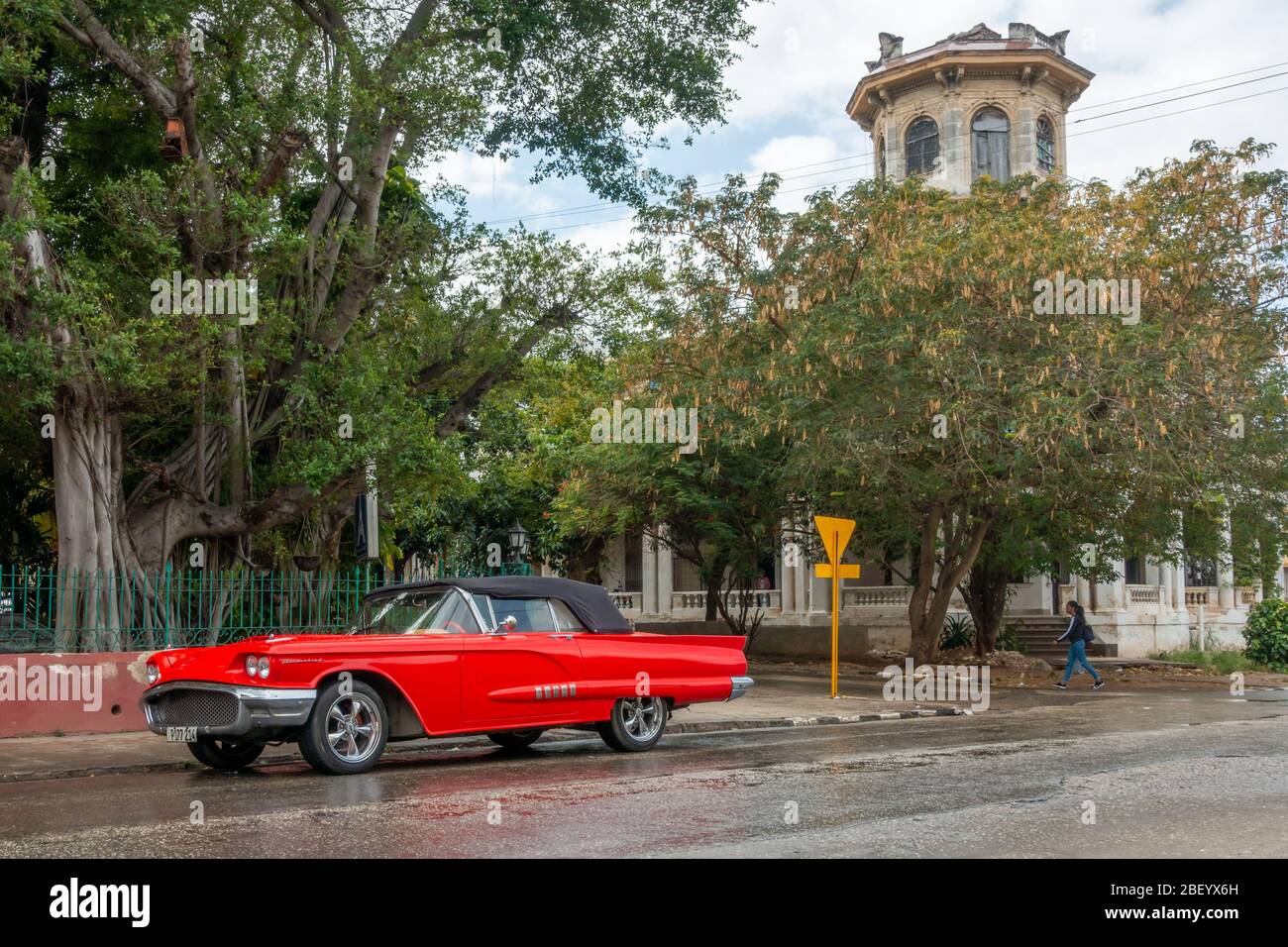 Un coche americano clásico, un Ford Thunderbird rojo sirve como taxi para los recorridos turísticos de la ciudad, esperando fuera del restaurante y cafetería Union Francesa, la Habana, Calle 17, C Foto de stock