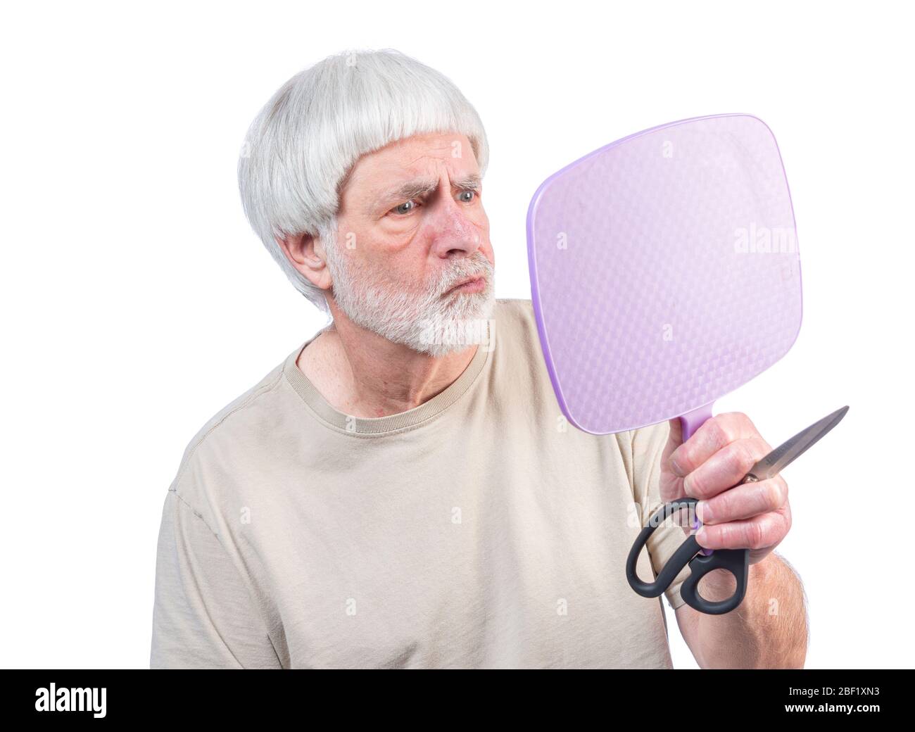 Disparo horizontal de un hombre de cabello gris que ha estado en cuarentena durante demasiado tiempo mirando el corte de pelo que acaba de darse y no está seguro de los resultados. Foto de stock