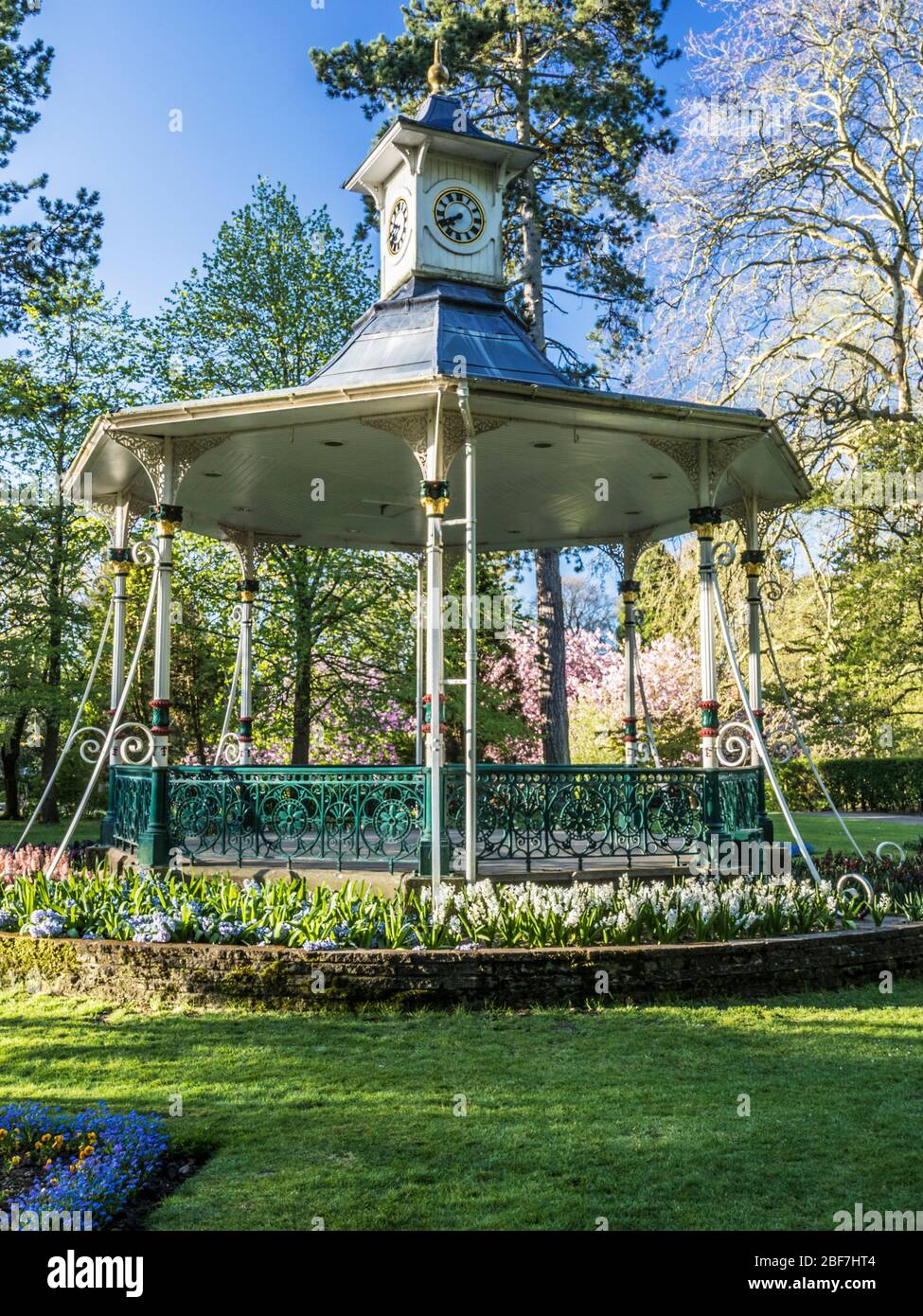 Un quiosco de música victoriano y ropa de cama de primavera en un parque público en el Reino Unido. Foto de stock