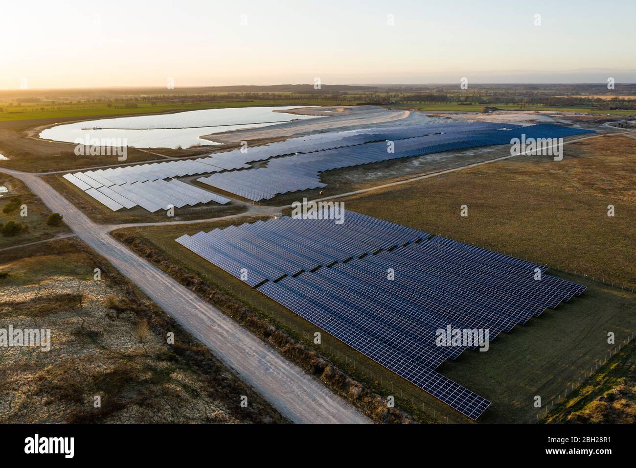 Alemania, Mecklemburgo-Pomerania Occidental, Luttow-Valluhn, Vista aérea de la central solar al atardecer Foto de stock