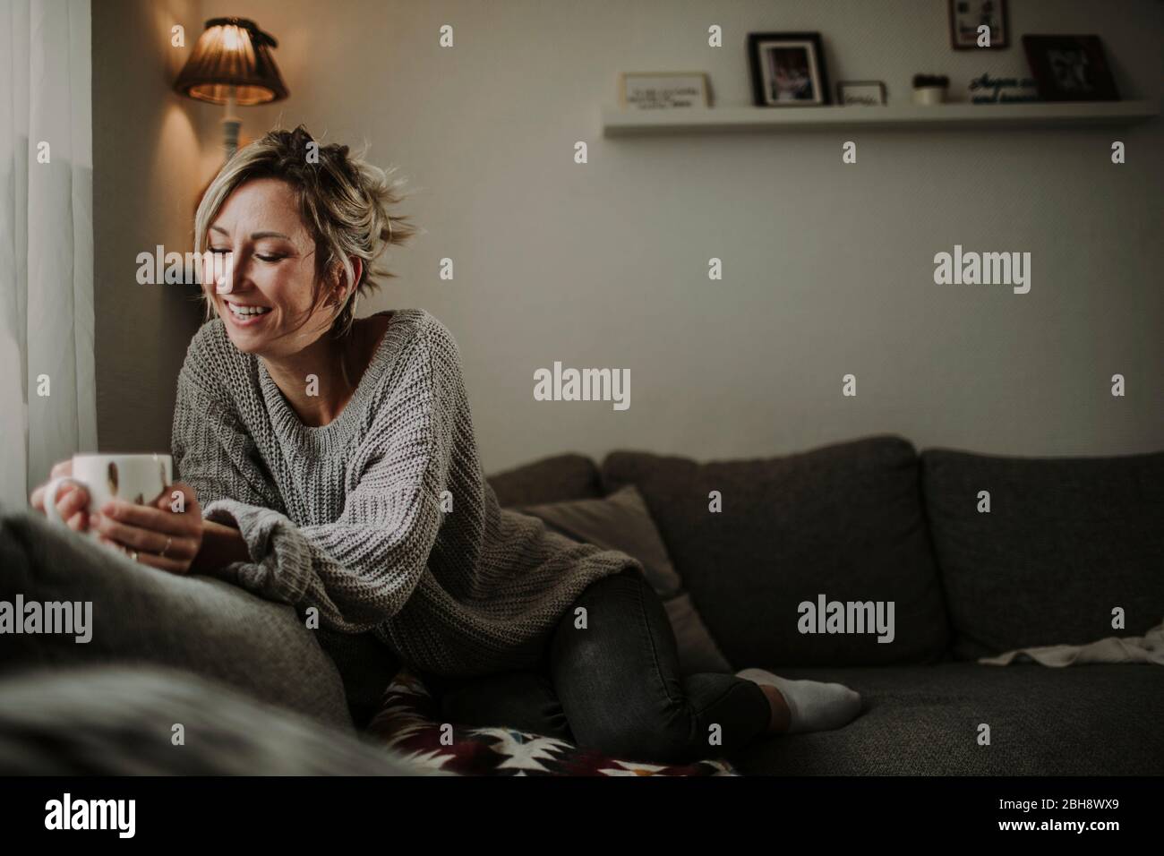 Sofá de la mesa Frau mit Teetasse Foto de stock