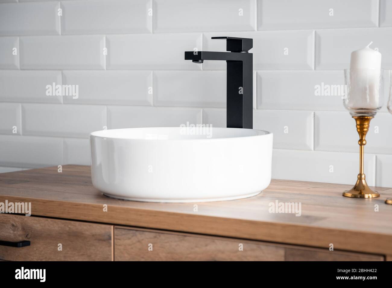 Grifo negro para agua y lavabo alto blanco separado sobre pedestal de  madera. Cuarto de baño estilo loft Fotografía de stock - Alamy