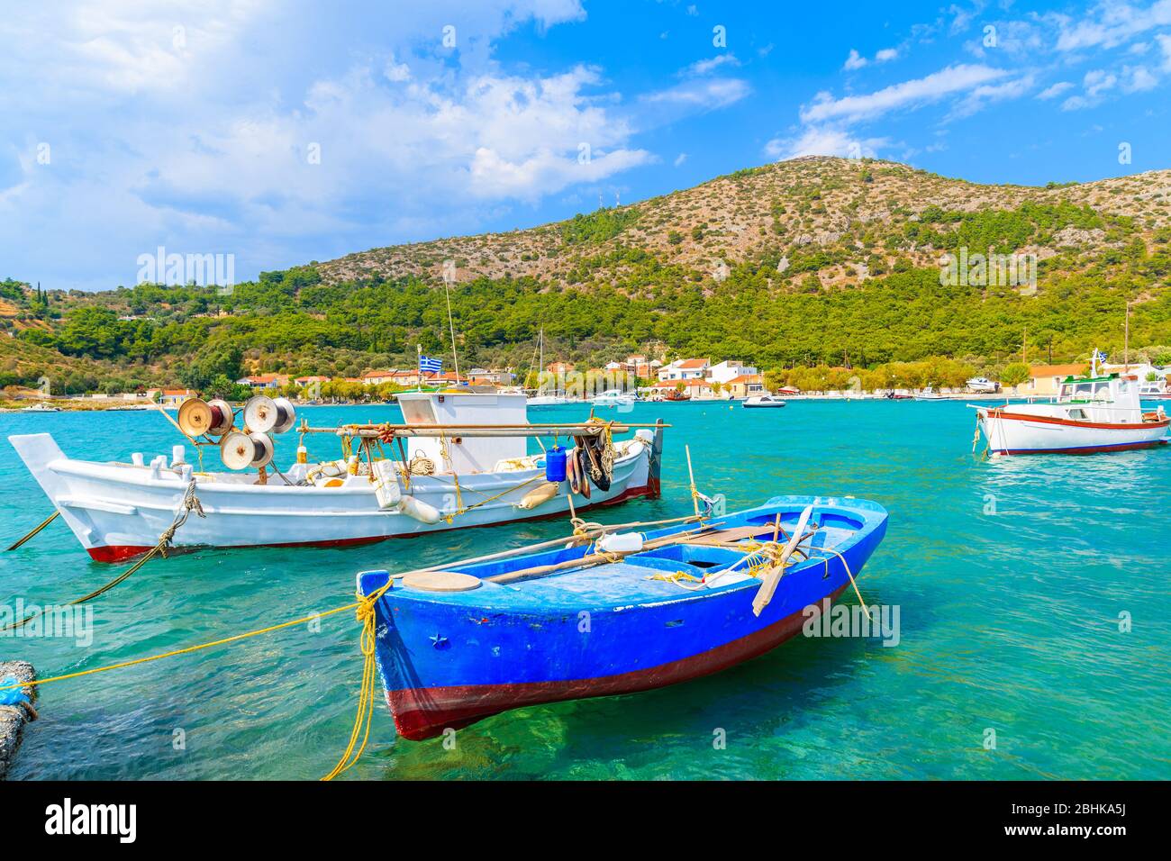 Coloridos barcos de pesca griegos en mar turquesa en la bahía de Posidonio, isla de Samos, Grecia Foto de stock