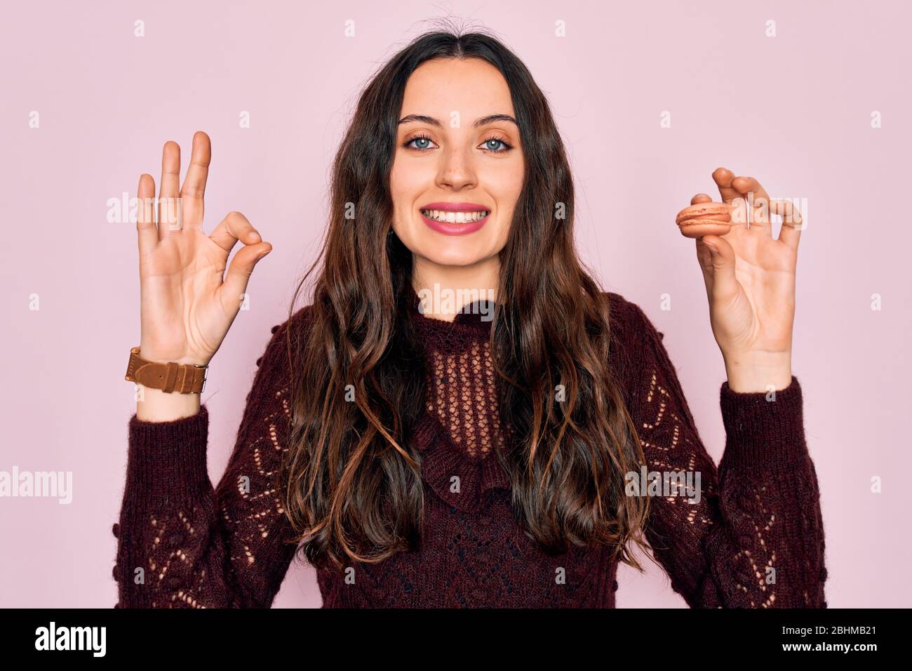 Joven hermosa mujer con ojos azules con gafas comiendo postre francés