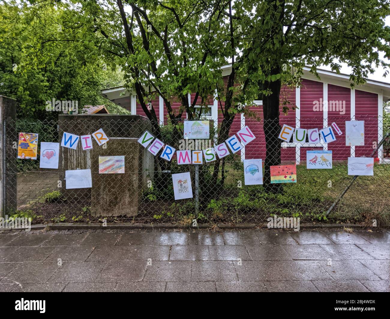 Munich, Baviera, Alemania. 28 de abril de 2020. Una escuela y centro de guardería (Kita, Kindertagesstätte) en Munich, Alemania tiene señales que indican ''Te extraño'' (Wir vermissen Euch) en frente. La determinación de si reabrir o no tales instalaciones de cuidado y escuela aún no se ha hecho. Crédito: Sachelle Babbar/ZUMA Wire/Alamy Live News Foto de stock