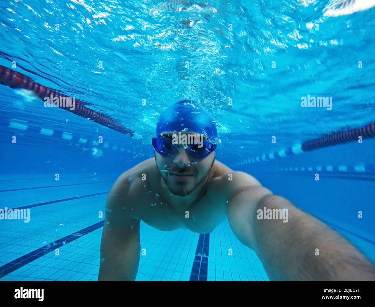 El hombre bucear en la piscina y tomar un selfie con gafas de natación  Fotografía de stock - Alamy