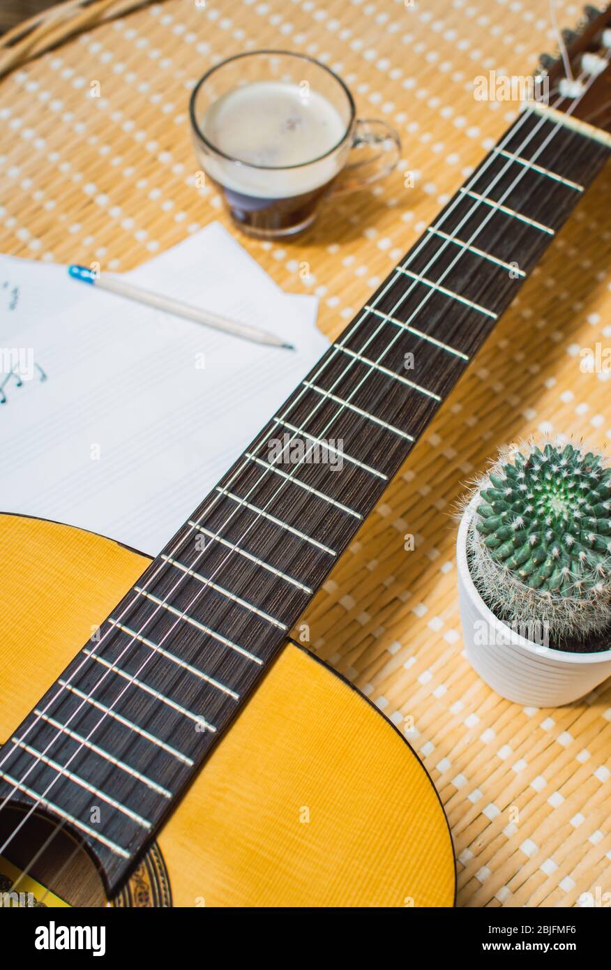 Hermosa vista superior de una guitarra clásica, libreta de música, café y  cactus. Un día relajante de música en casa Fotografía de stock - Alamy