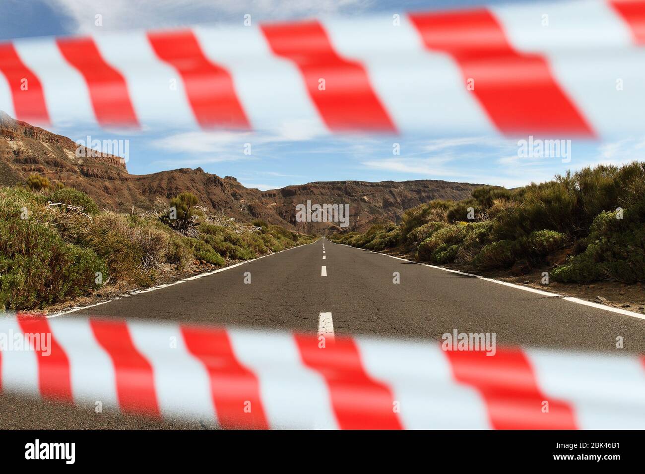 Carretera vacía en España cerrada con cinta de advertencia Foto de stock
