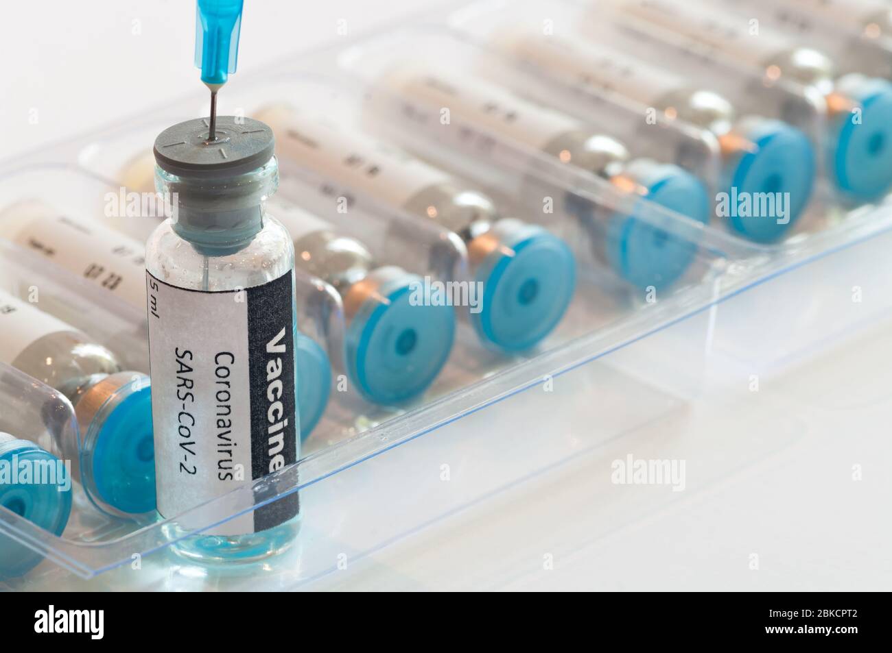 Jeringa médica con vial de ampolla de vidrio con vacuna contra coronavirus COVID-19. Foto de stock